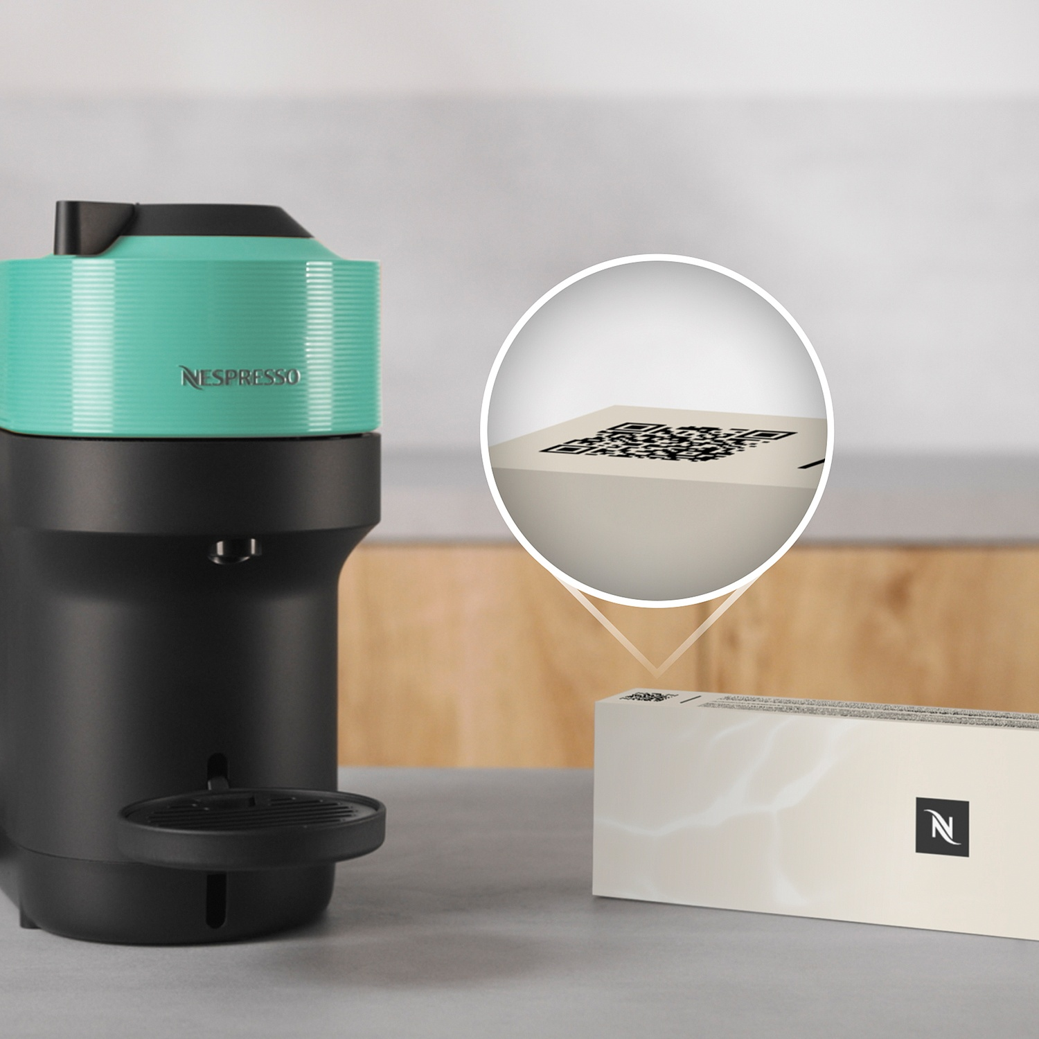 A Nespresso coffee machine with a turquoise top and black body.