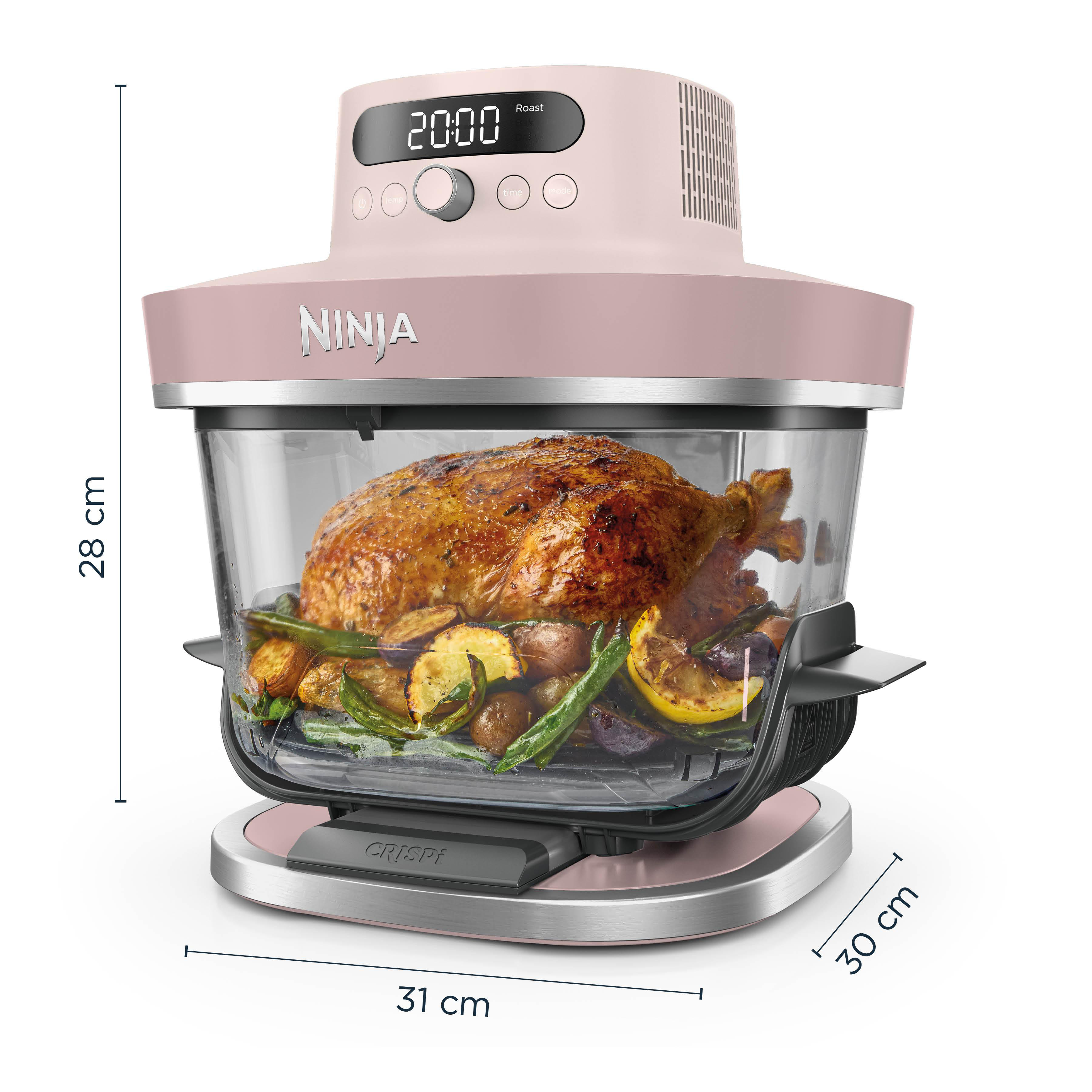 Ein rosafarbener Ninja-Ofen mit einem gebratenen Huhn und Gemüse.