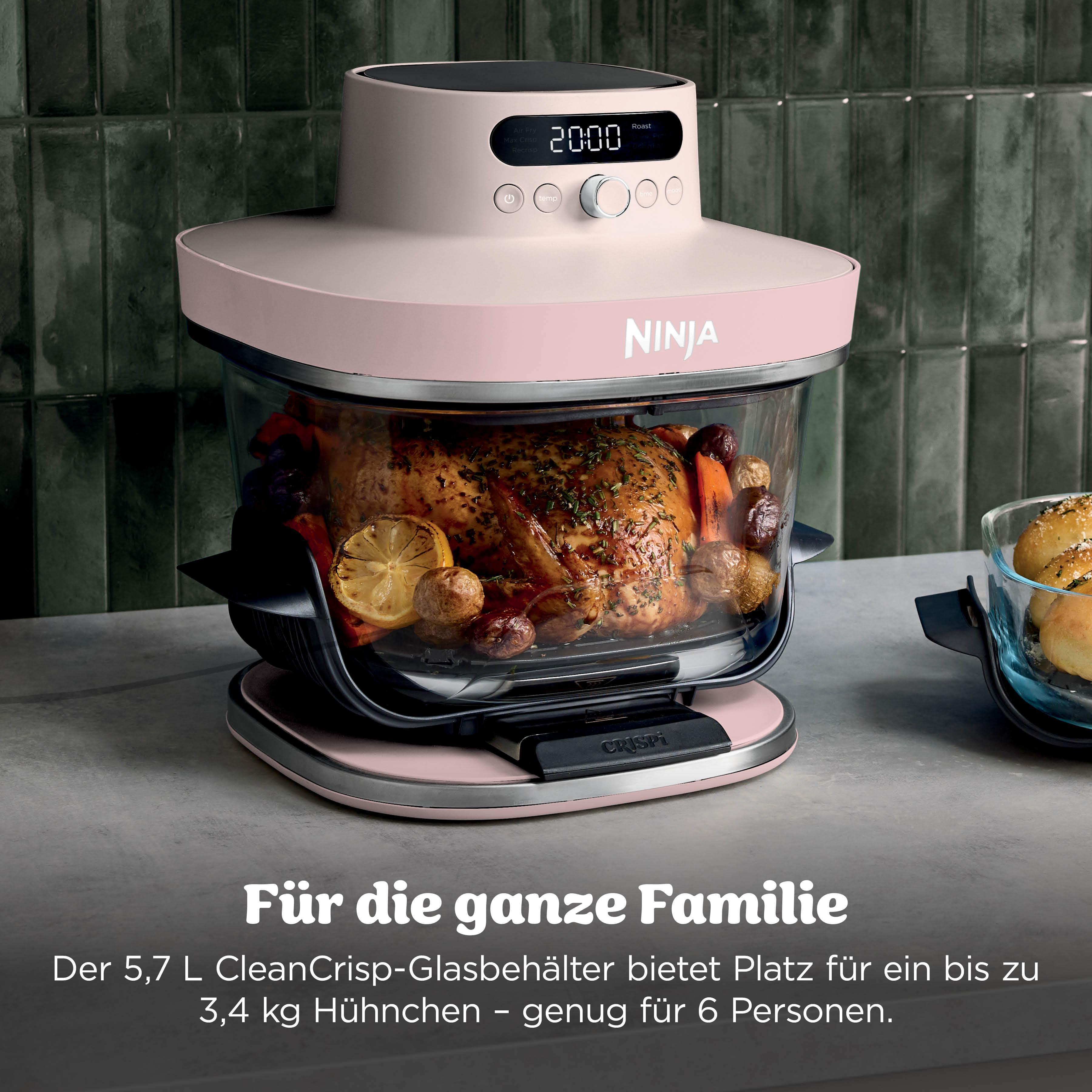 Ein rosafarbener Ninja Heißluftfritteuse mit einem gebratenen Huhn und Gemüse.
