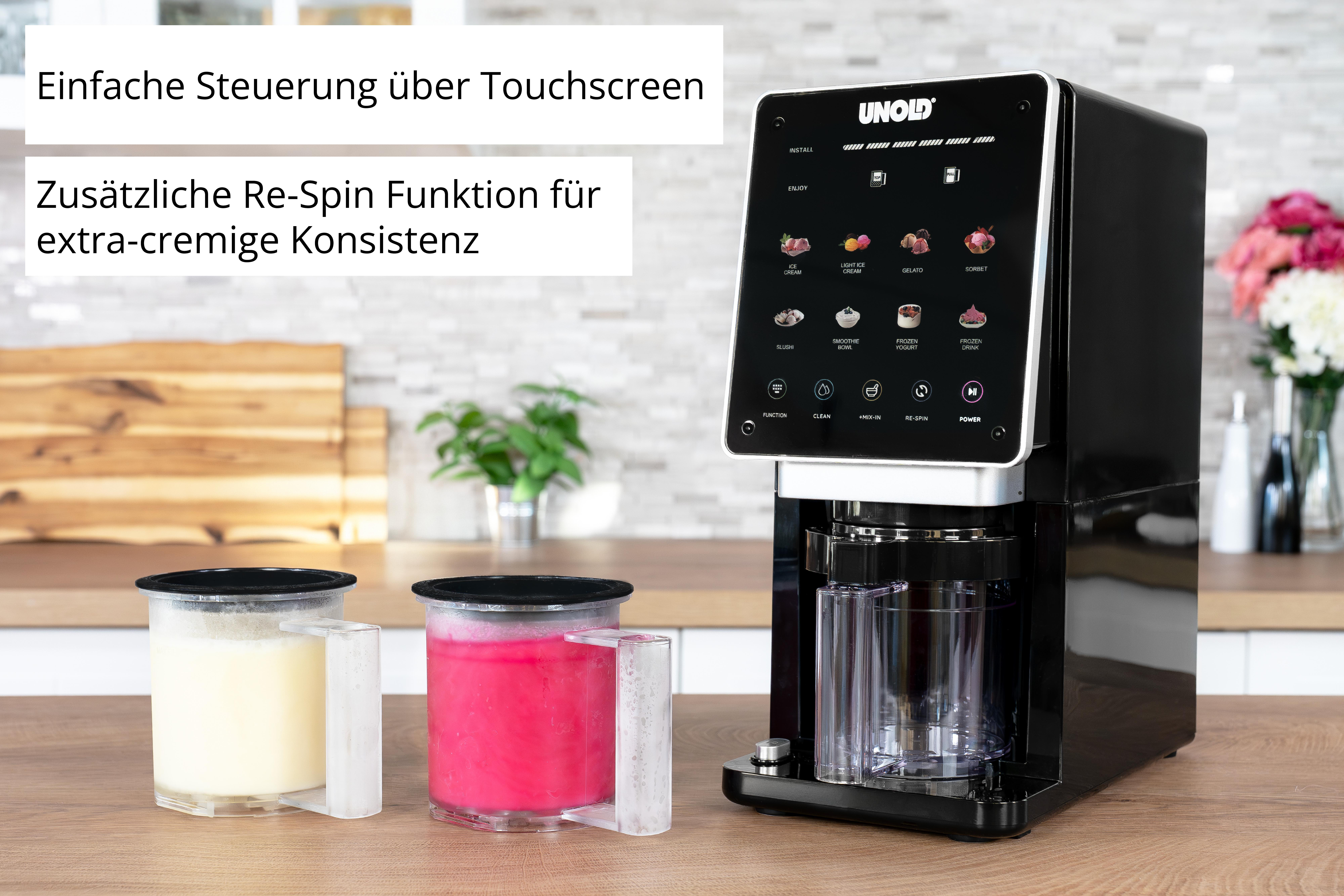 Ein schwarzer Eisbereiter mit Touchscreen und zwei Behältern, einer mit gelber, einer mit pinker Masse.