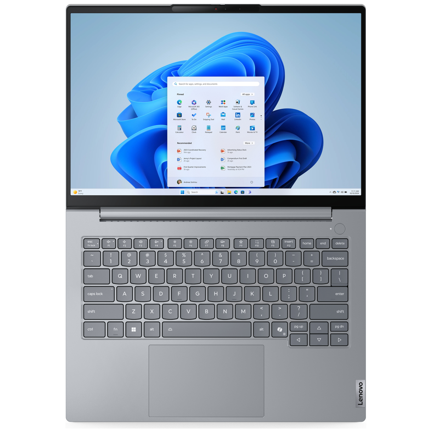 Gray Lenovo laptop with open screen showing Windows 11 and keyboard.
