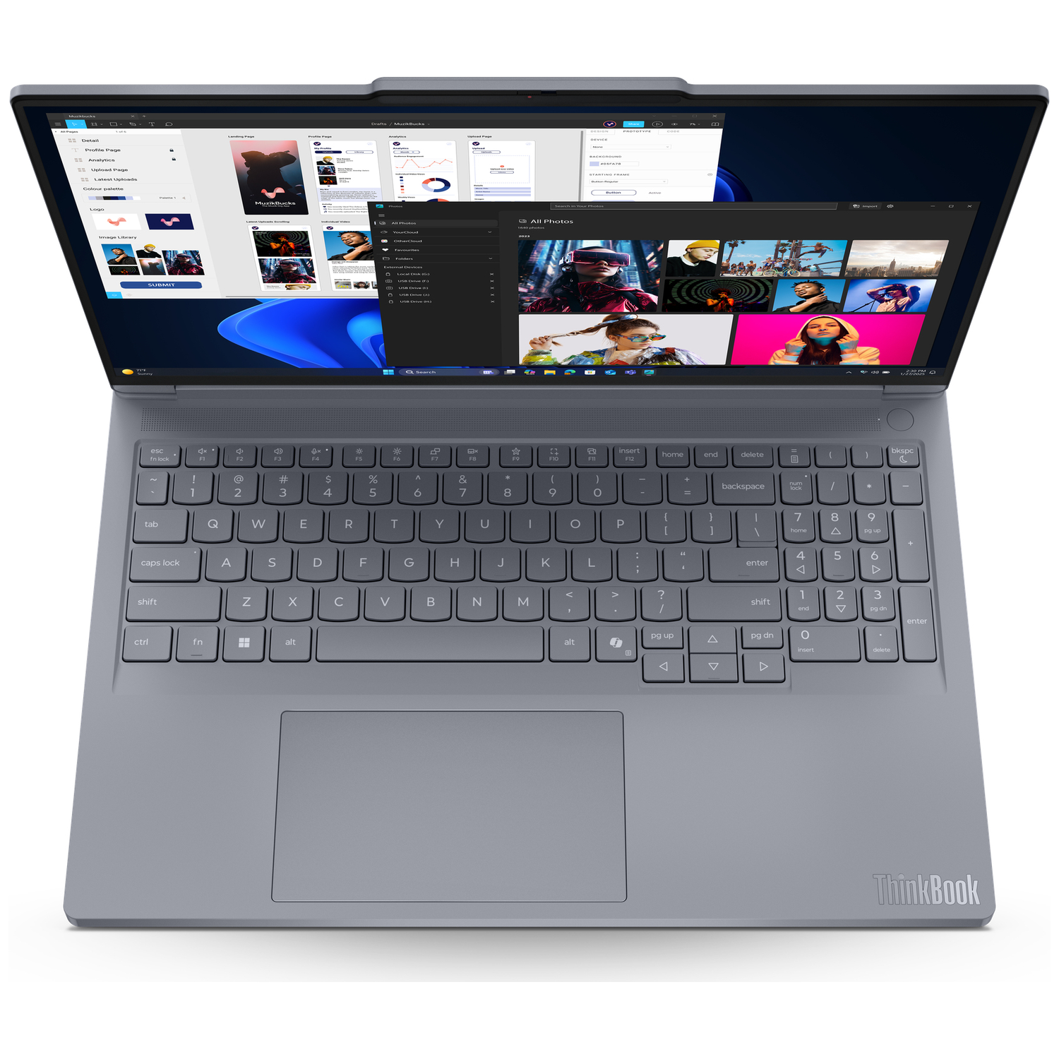 An open gray laptop displaying various photos and web pages on its screen.