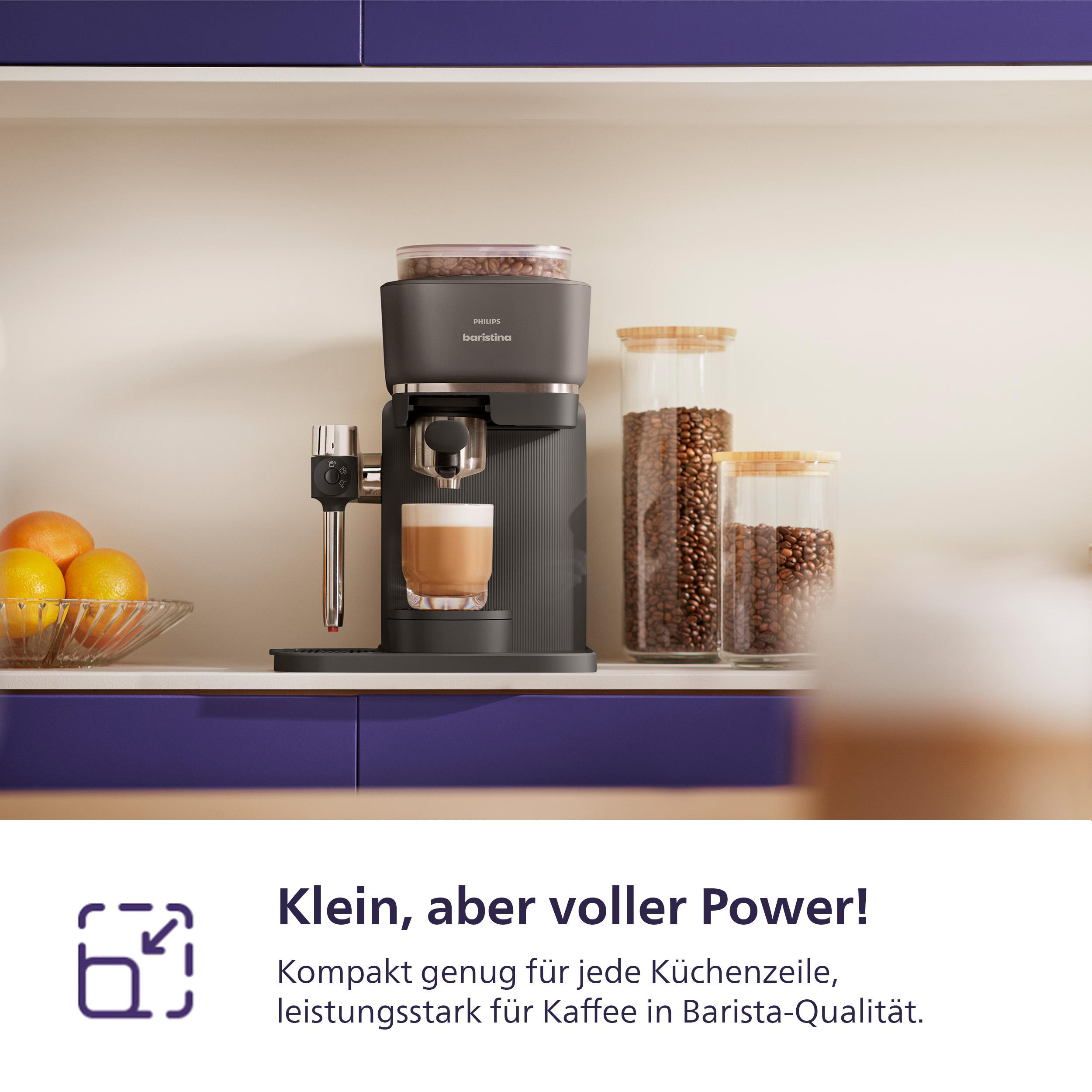 Dunkelgraue Kaffeemaschine mit Glasbehältern voller Bohnen und Orangen.