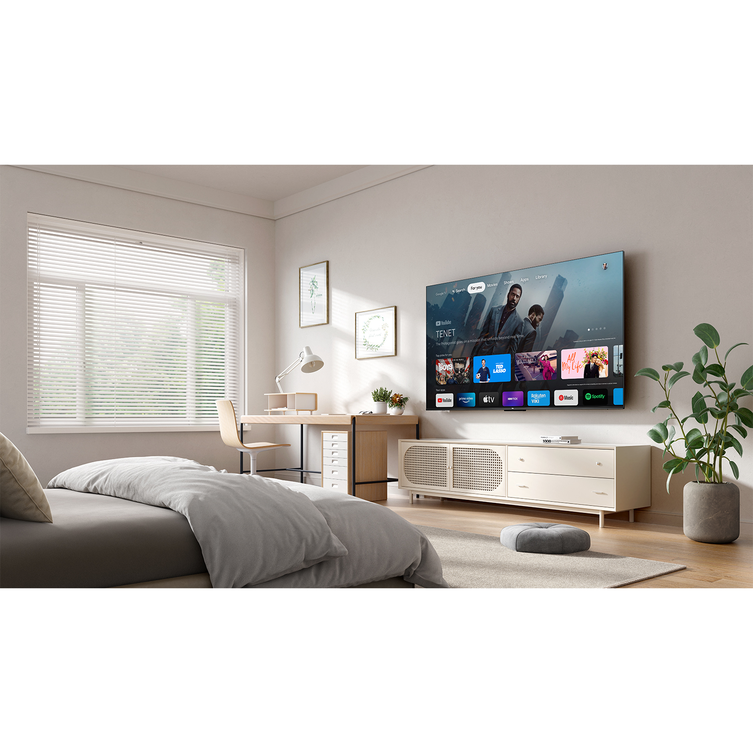 Ein modernes Schlafzimmer mit einem großen Bett, Schreibtisch und Fernseher.
