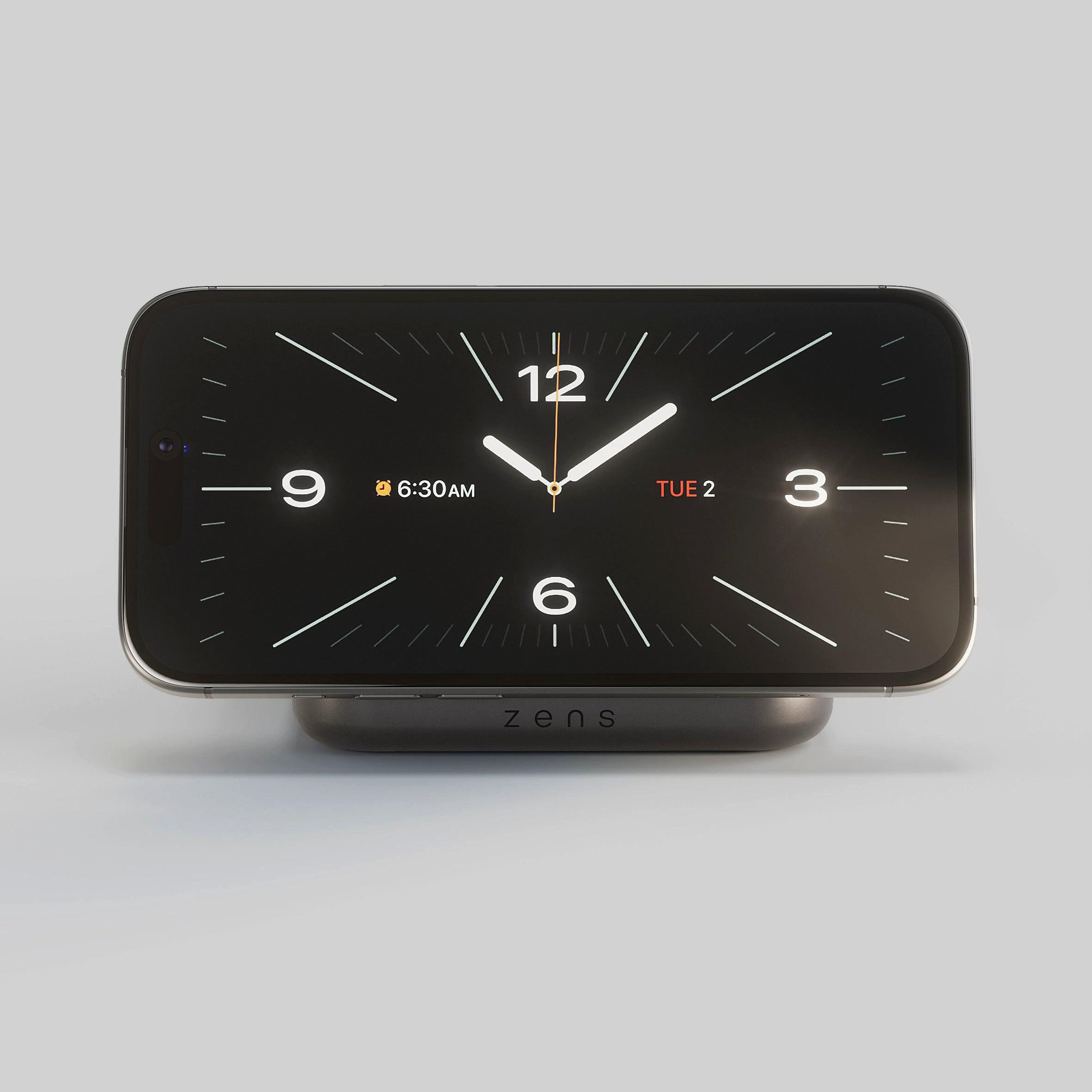Ein Smartphone mit Uhranzeige auf einem Lade-Ständer. 6:30 AM, Dienstag 2.