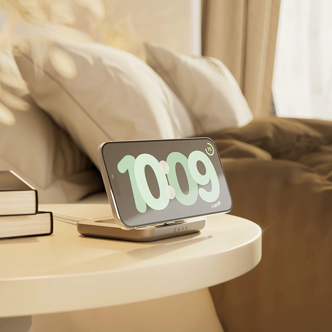 Ein Smartphone zeigt 10:09 Uhr auf einem Nachttisch neben einem Bett.