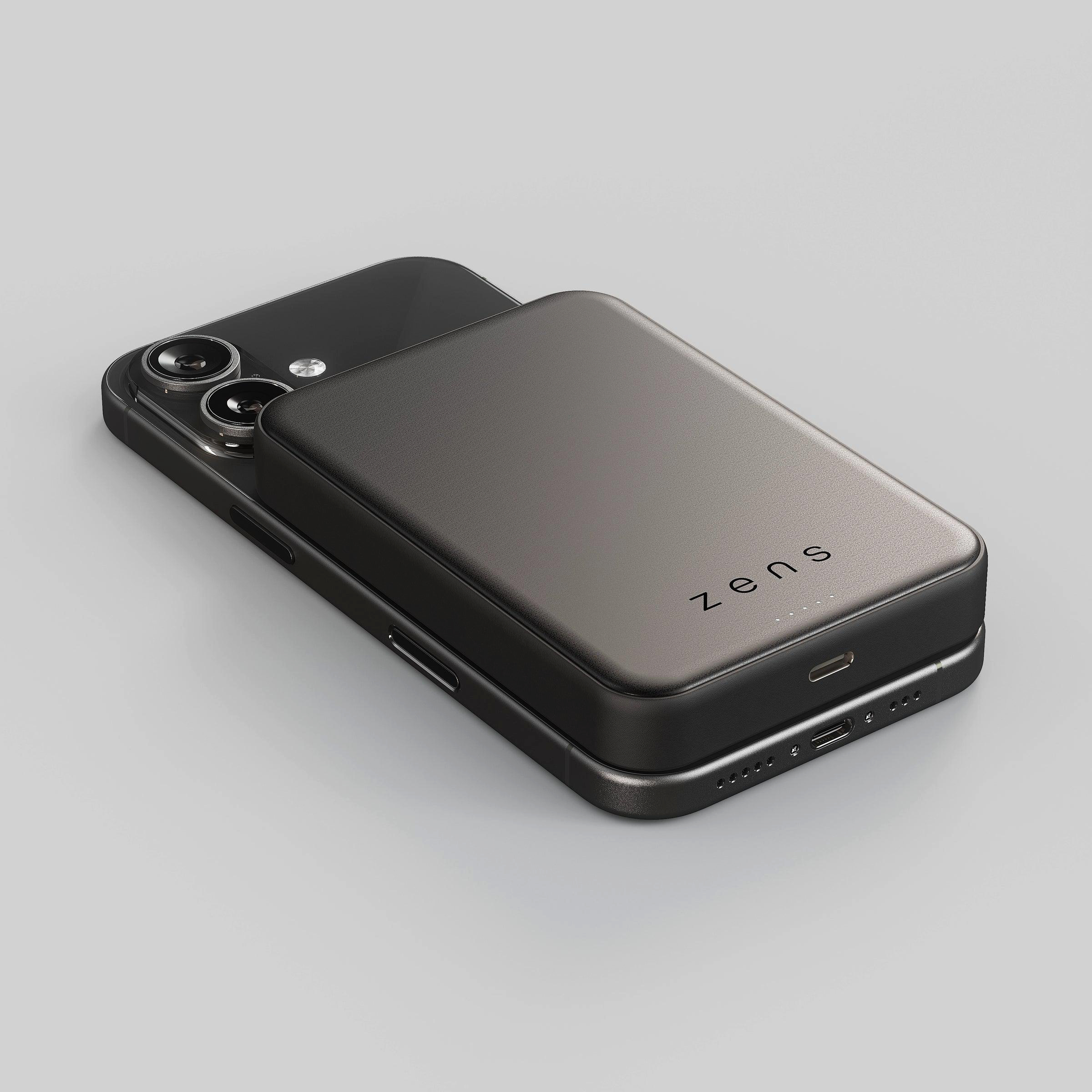 Ein graues Smartphone liegt auf einem grauen Hintergrund, mit einem grauen Power-Akku.