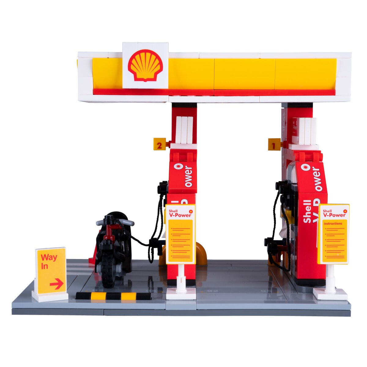 Shell benzinkút modell két pumpával, motorral és "Bejárat" táblával.