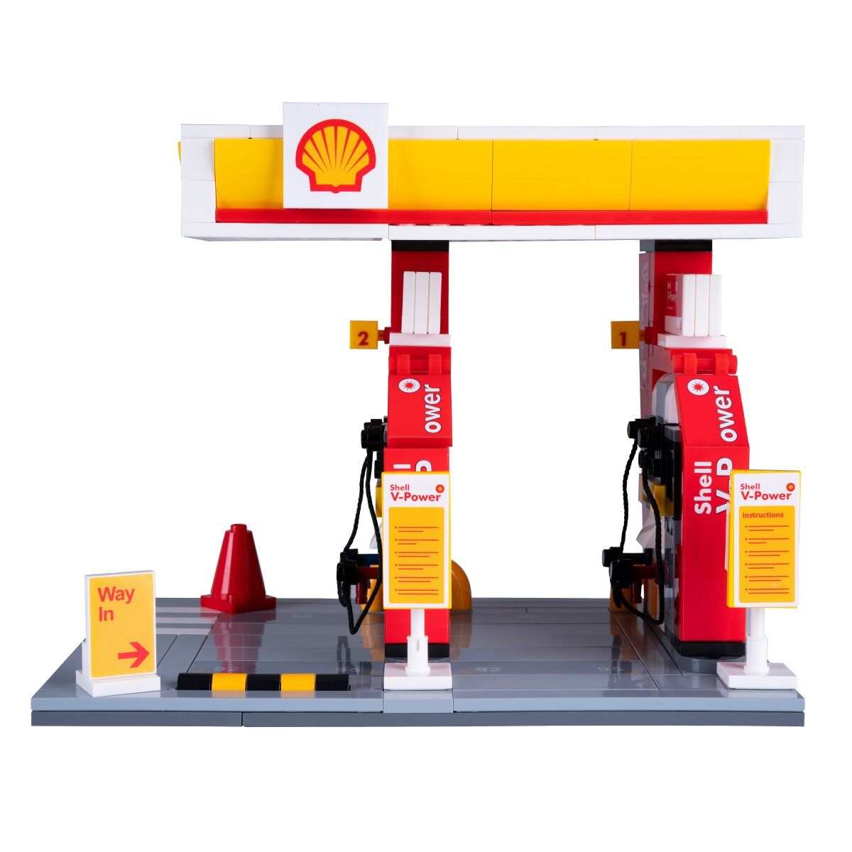 Játék benzinkút készlet Shell logóval, szivattyúkkal és táblákkal.
