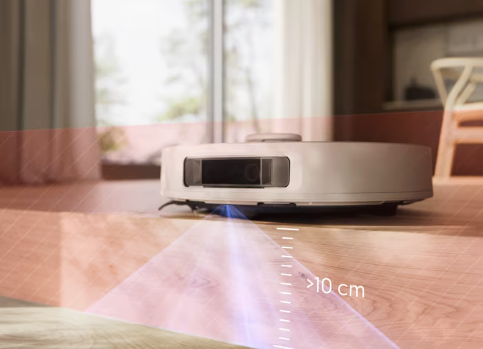 Egy fehér robotporszívó fa padlón, piros átfedéssel, amely akadályokat jelez.