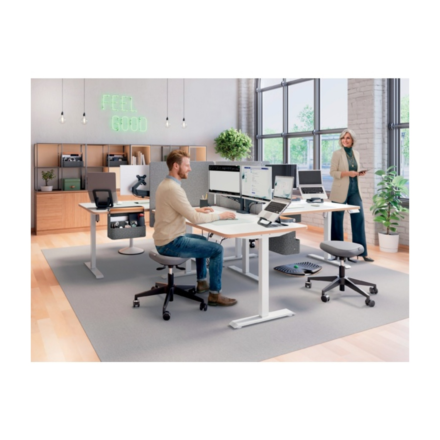 Uomini e donne lavorano a scrivanie regolabili in un ufficio moderno. Insegna al neon.