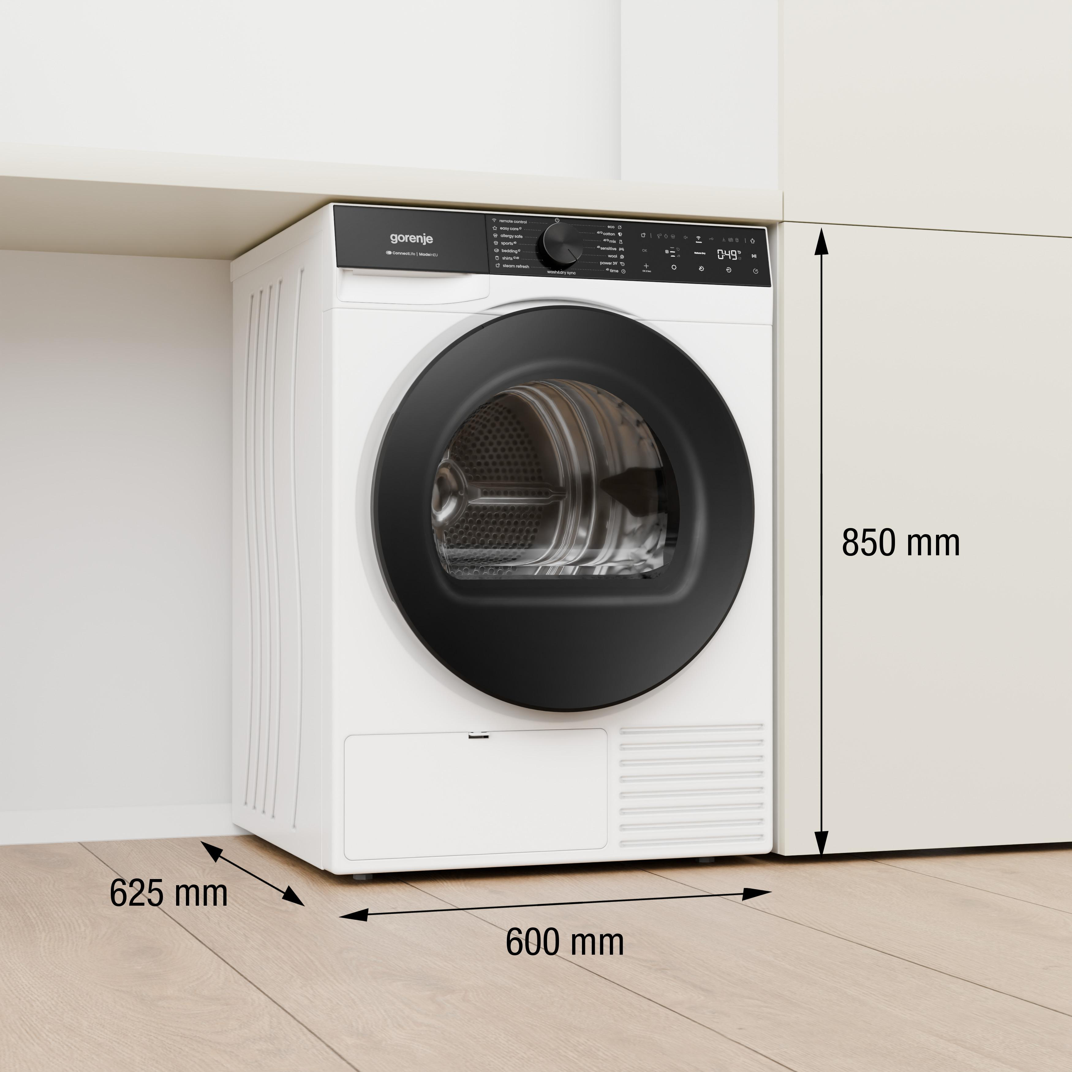 Ein weißer Gorenje Trockner mit schwarzer Tür steht auf einem Holzboden.