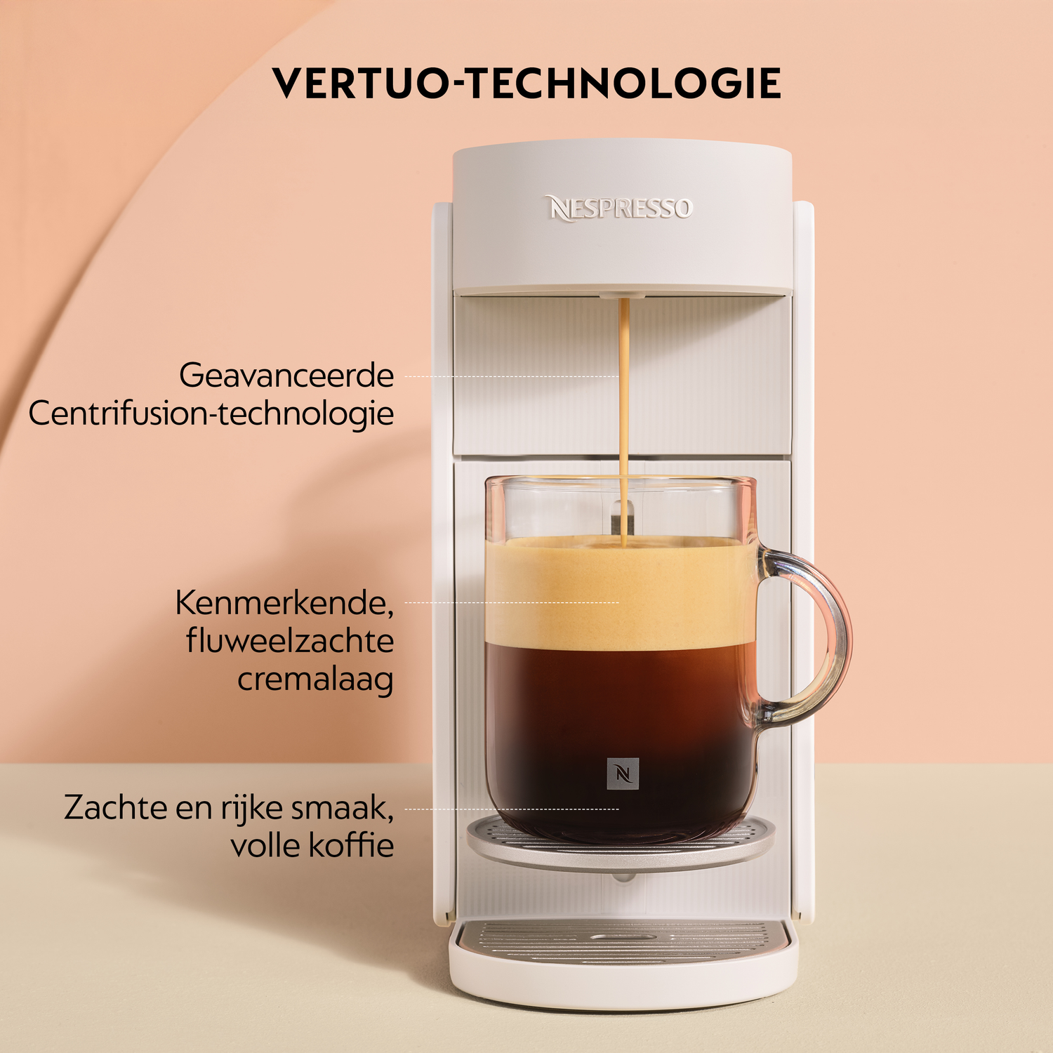 White Nespresso Vertuo machine brewing coffee with creamy foam into a glass cup.