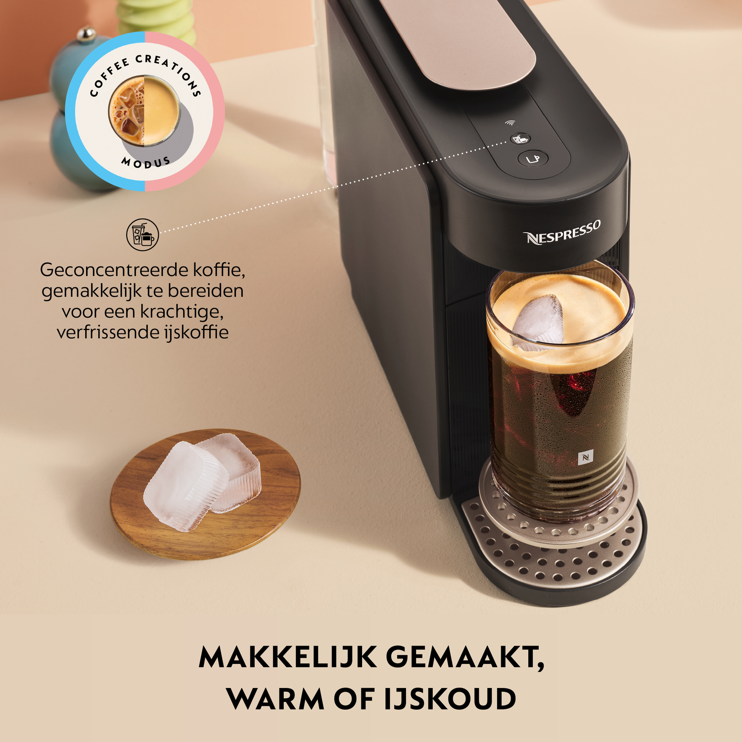 Nespresso machine with a glass of iced coffee and ice cubes nearby.