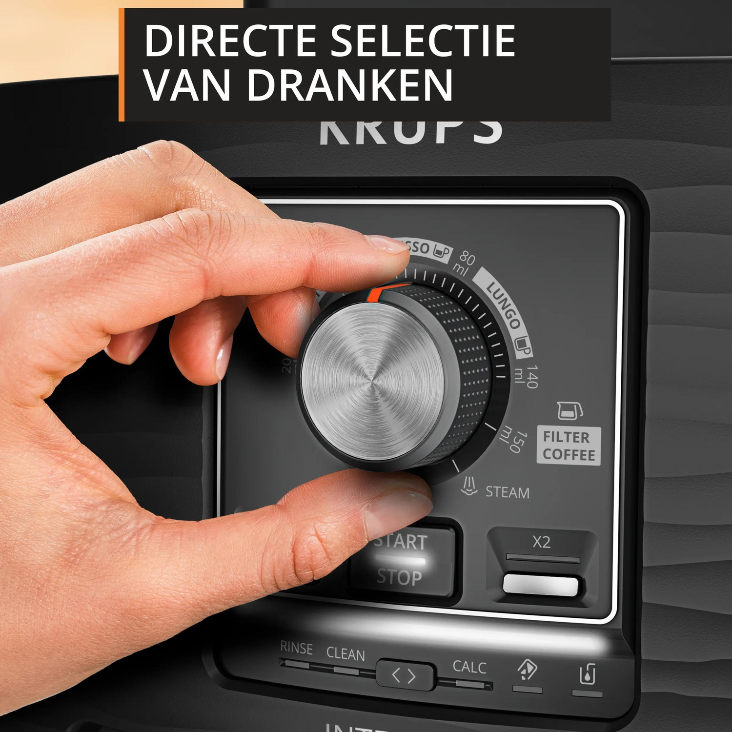 A hand turns a dial on a coffee machine with symbols.