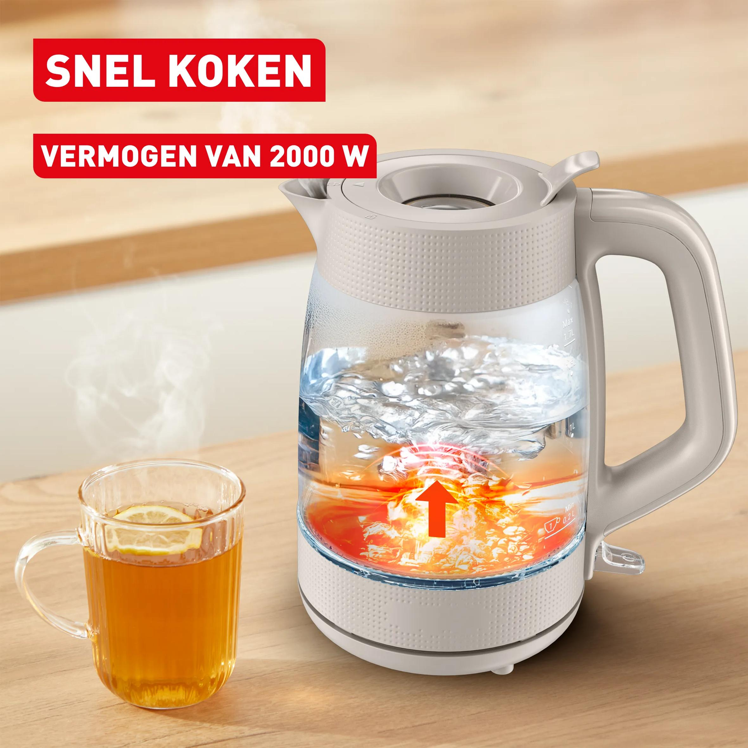 A kettle boils water, next to it a cup of tea with lemon.