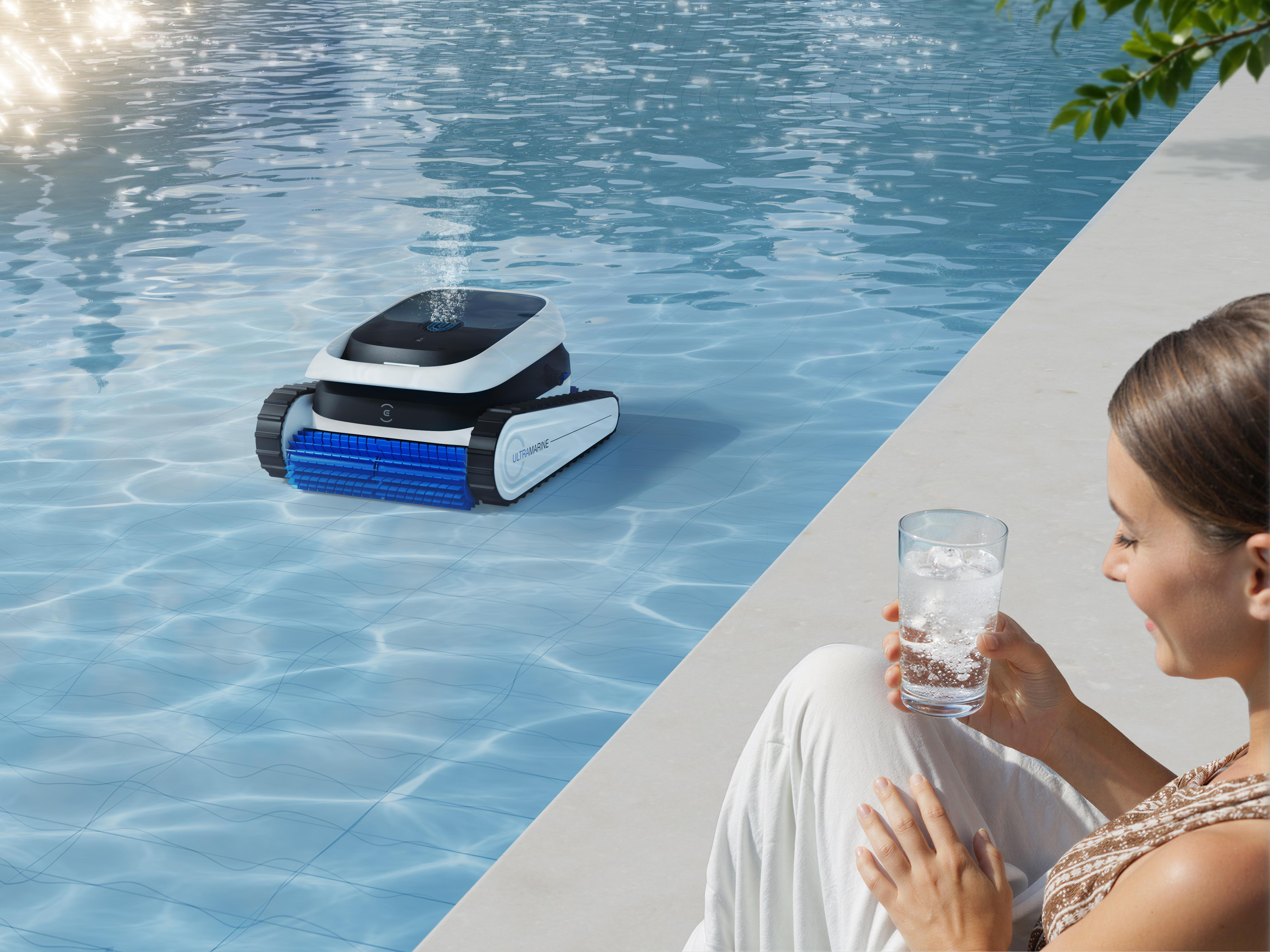 Ein Poolroboter reinigt das Wasser, während eine Frau mit einem Getränk entspannt.