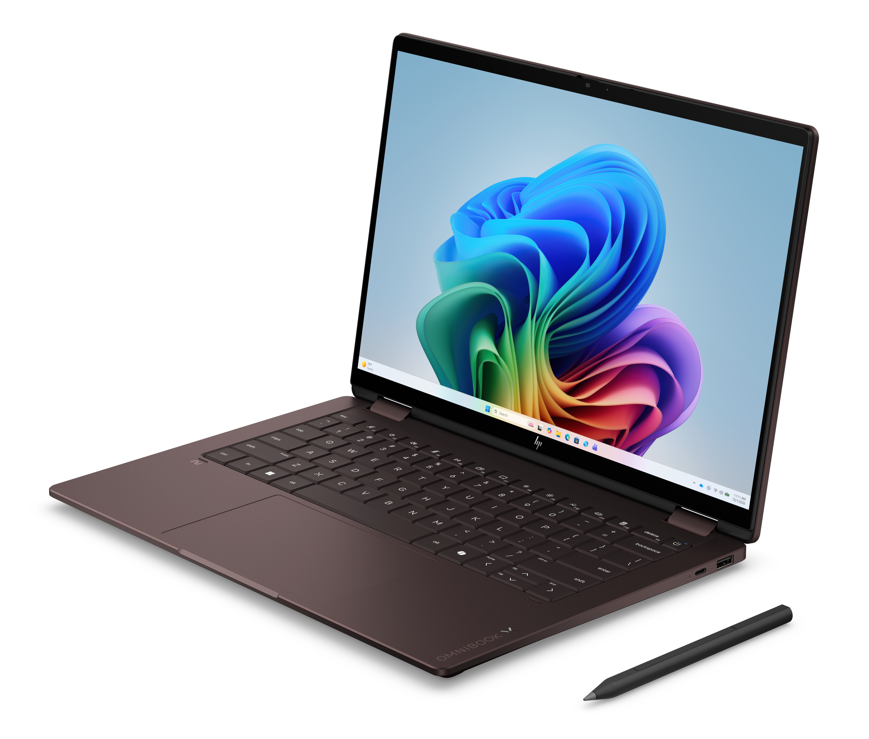Brązowy laptop jest otwarty. Obok leży rysik.