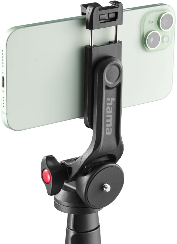 Uno smartphone verde chiaro tenuto in un supporto per telefono nero attaccato a un treppiede.