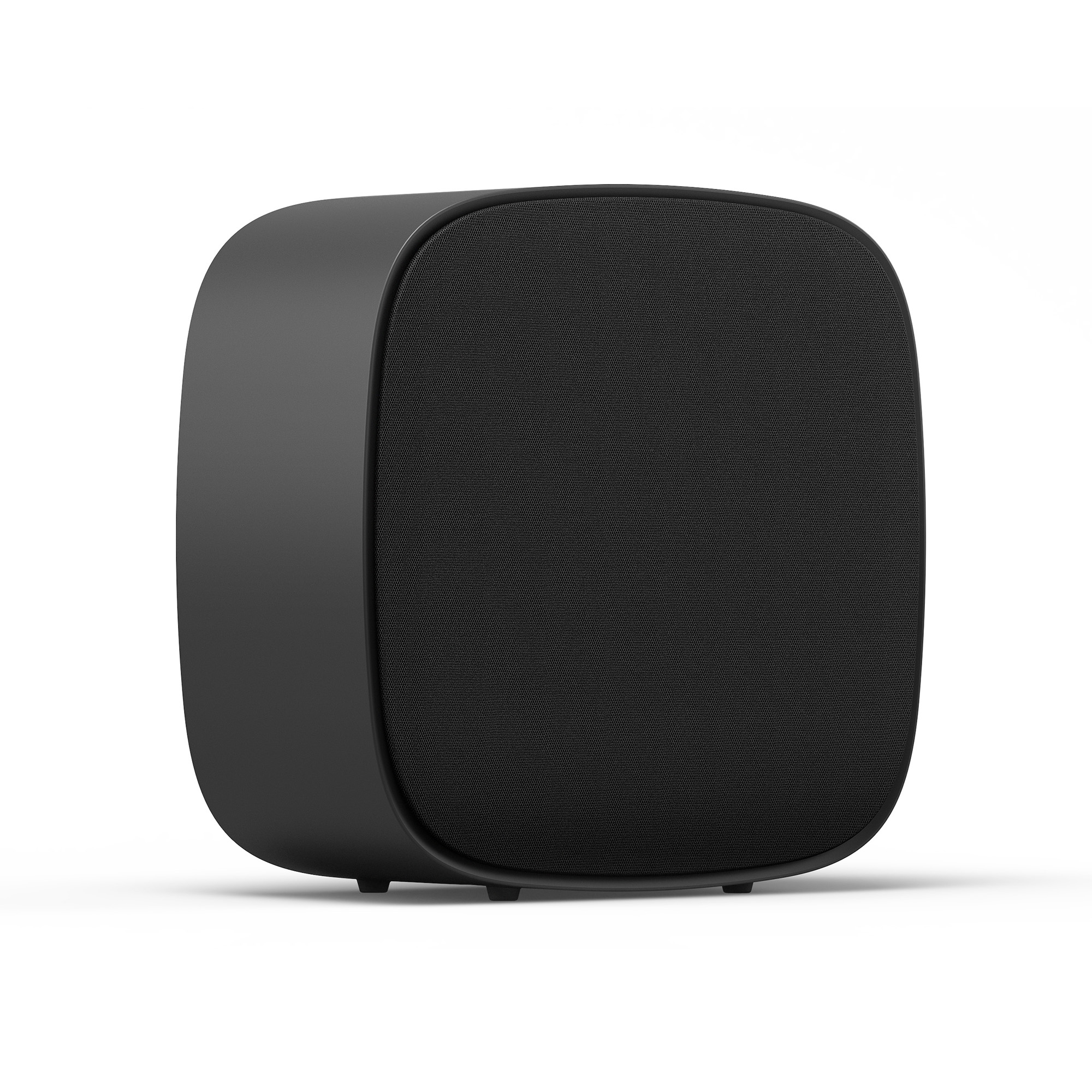 Un altavoz rectangular negro con esquinas redondeadas descansa sobre cuatro patas pequeñas.