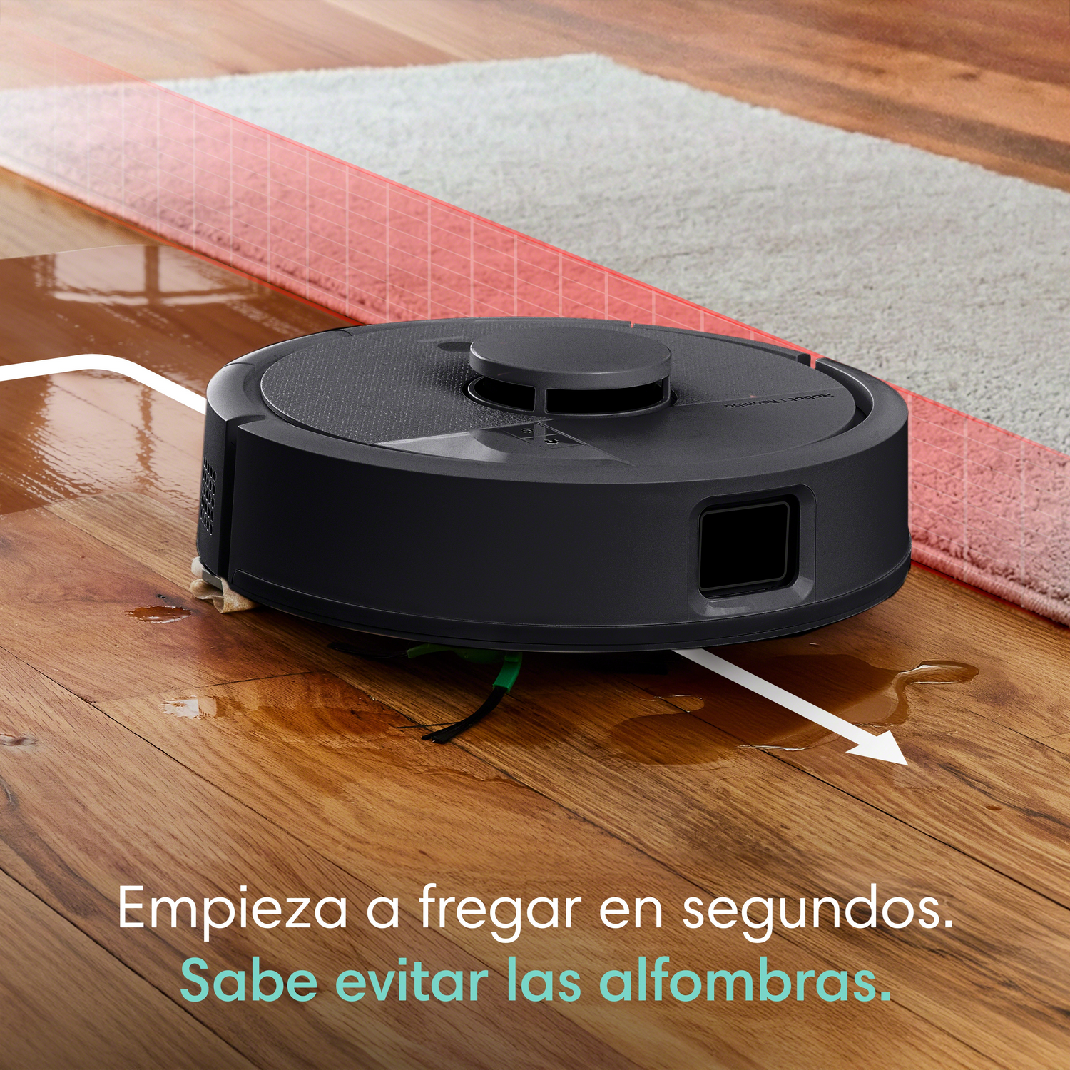 Un robot aspirador negro friega un suelo de madera, evitando una alfombra.