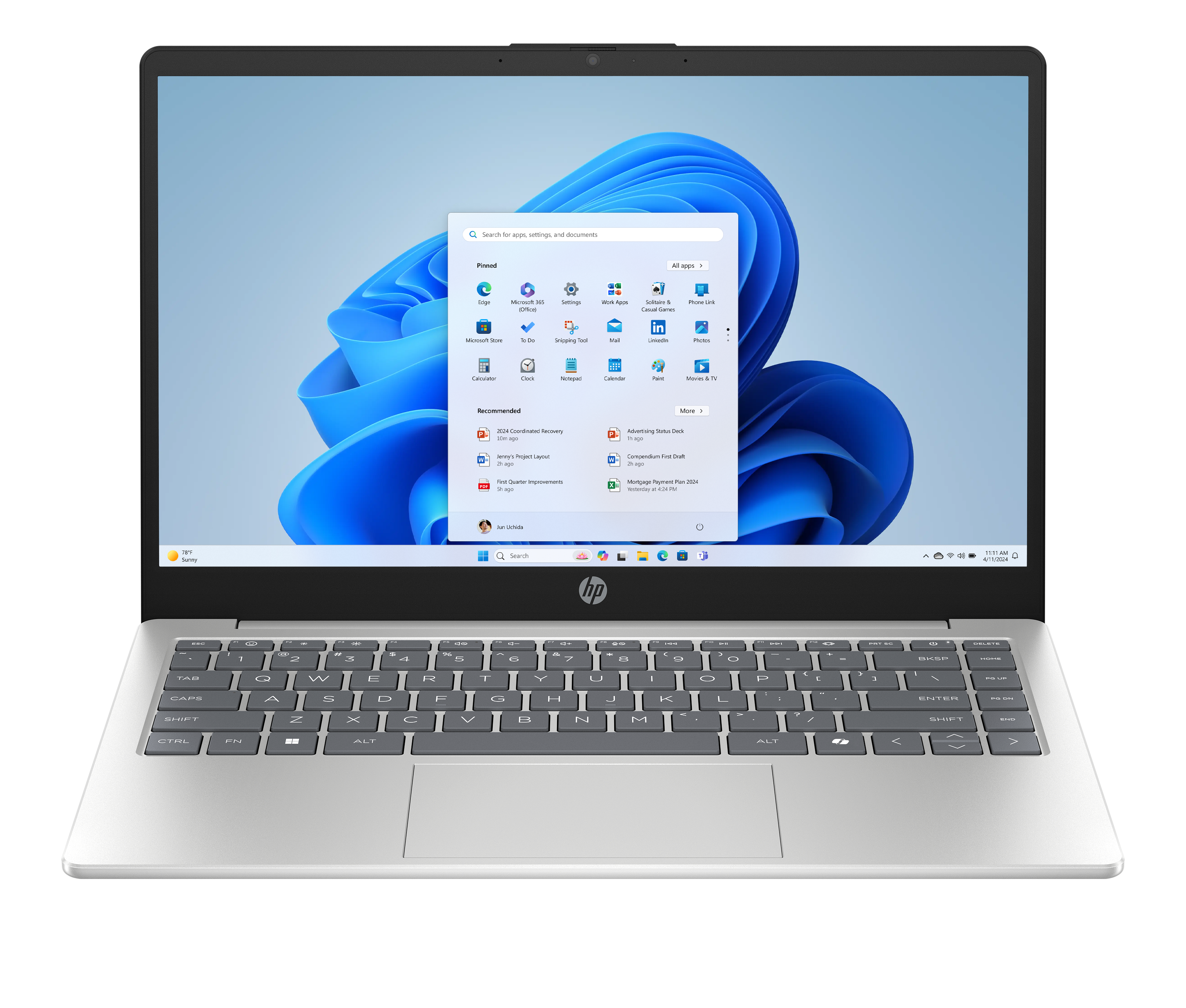 Ein silberner Laptop mit Windows 11 und geöffnetem Startmenü. Blaue Wellen-Tapete.
