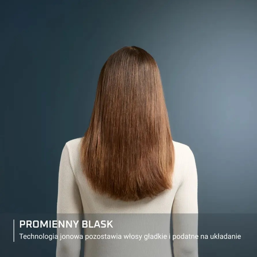 Widok z tyłu kobiety z długimi, brązowymi, prostymi włosami i białym swetrem.