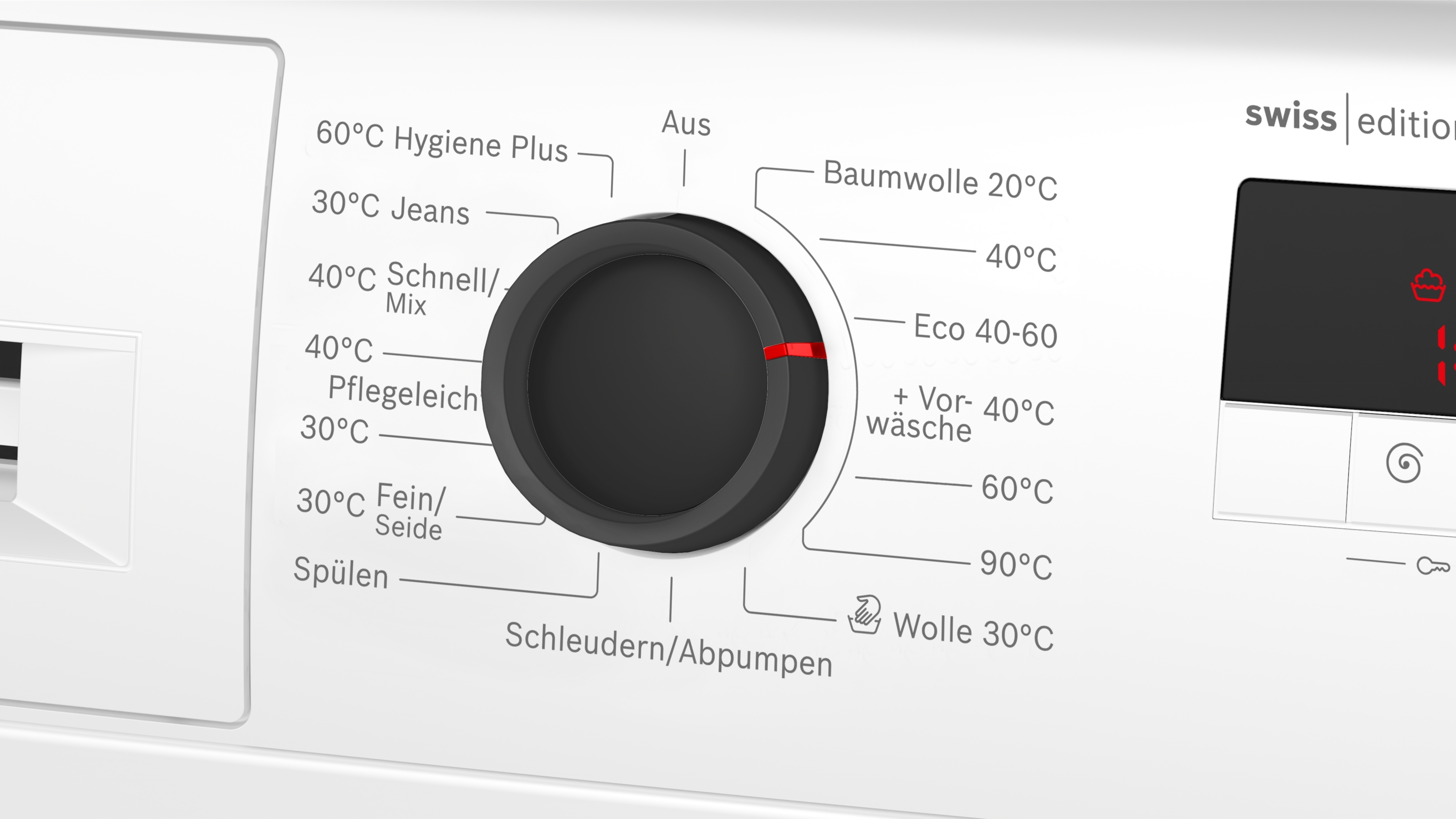 Eine weiße Waschmaschine mit einem schwarzen Drehknopf, der auf 40°C Pflegeleicht eingestellt ist.