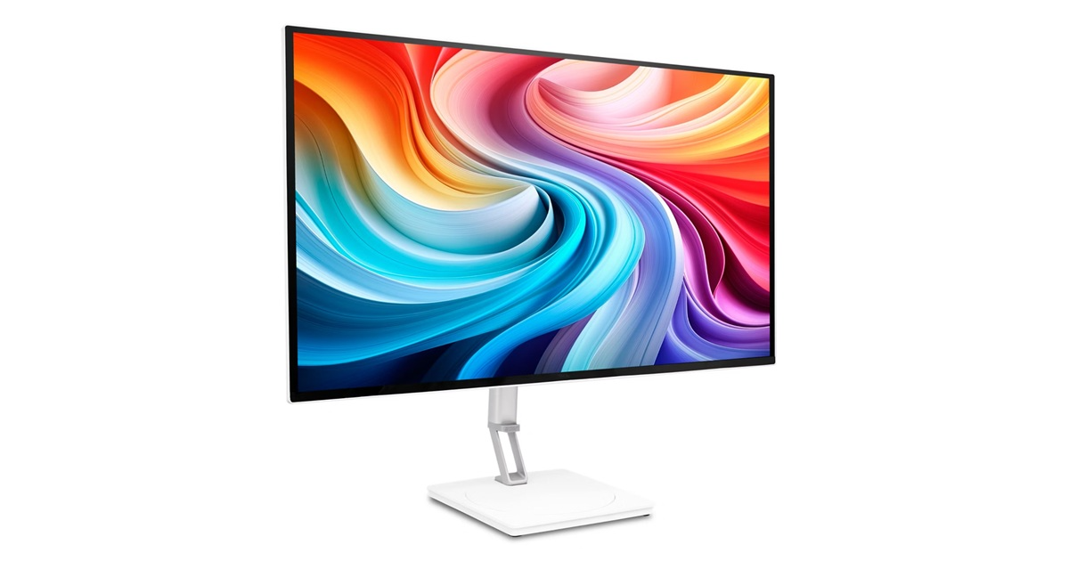 Egy modern monitor színes, örvénylő háttérrel, fehér állványon.