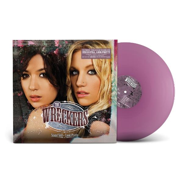 Eine lila Schallplatte neben dem Cover des Albums "Stand Still - Look Pretty" von The Wreckers.