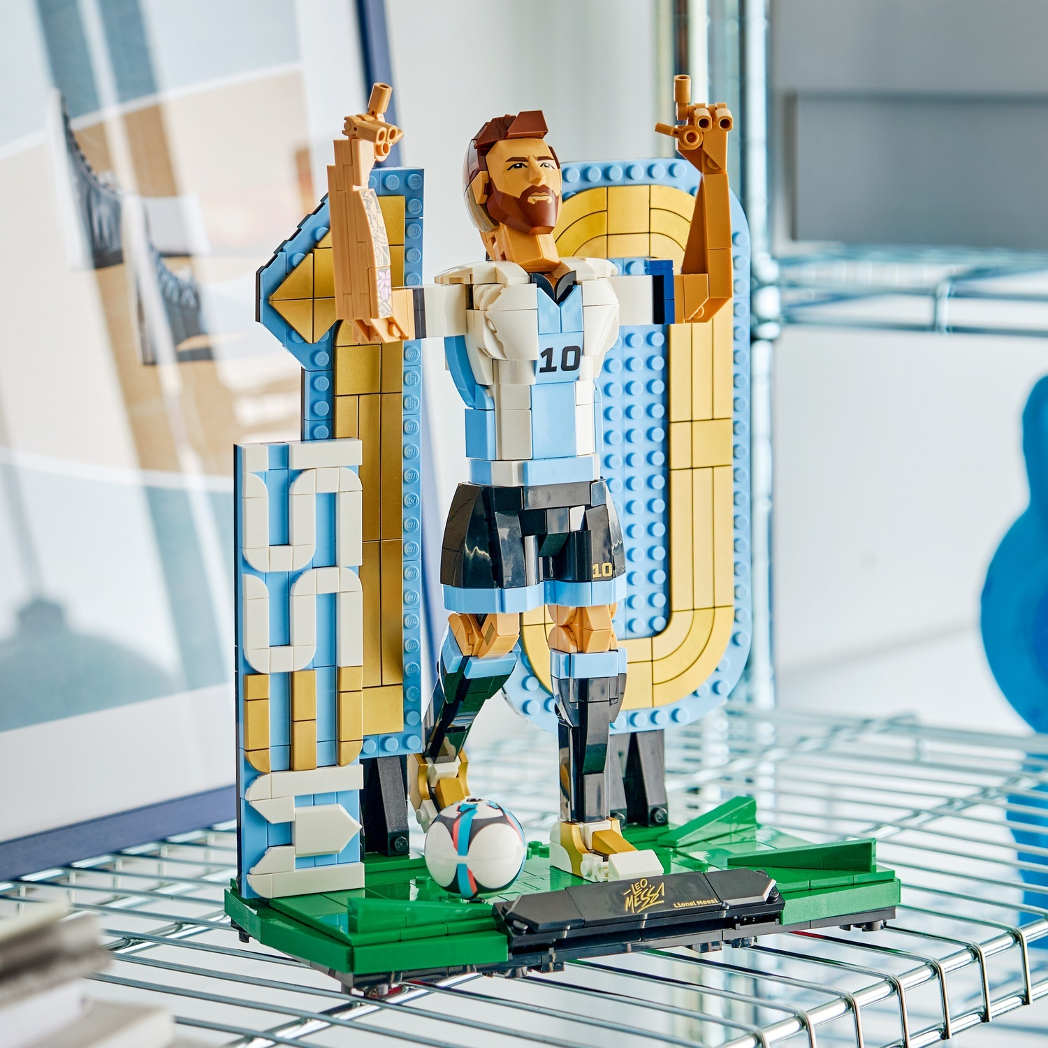 Figura Lego di Lionel Messi in tenuta biancoazzurra con numero 10, davanti a un grande 10.