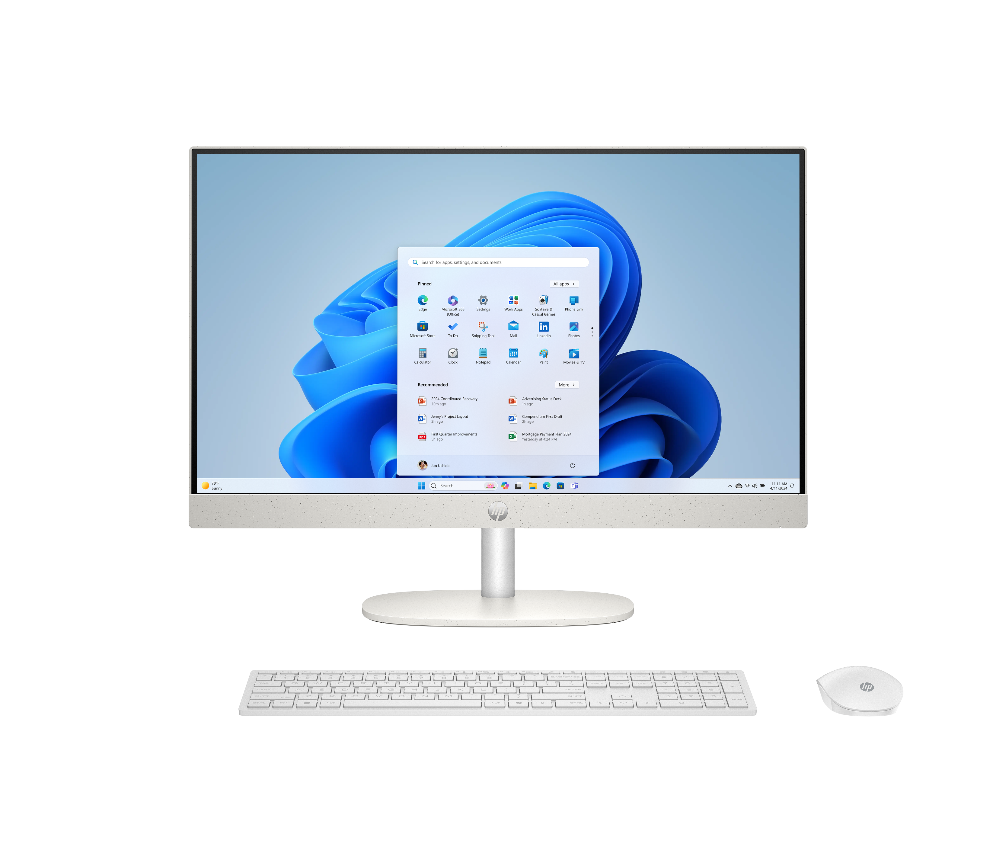 Een witte all-in-one computer met toetsenbord en muis tegen een zwarte achtergrond.