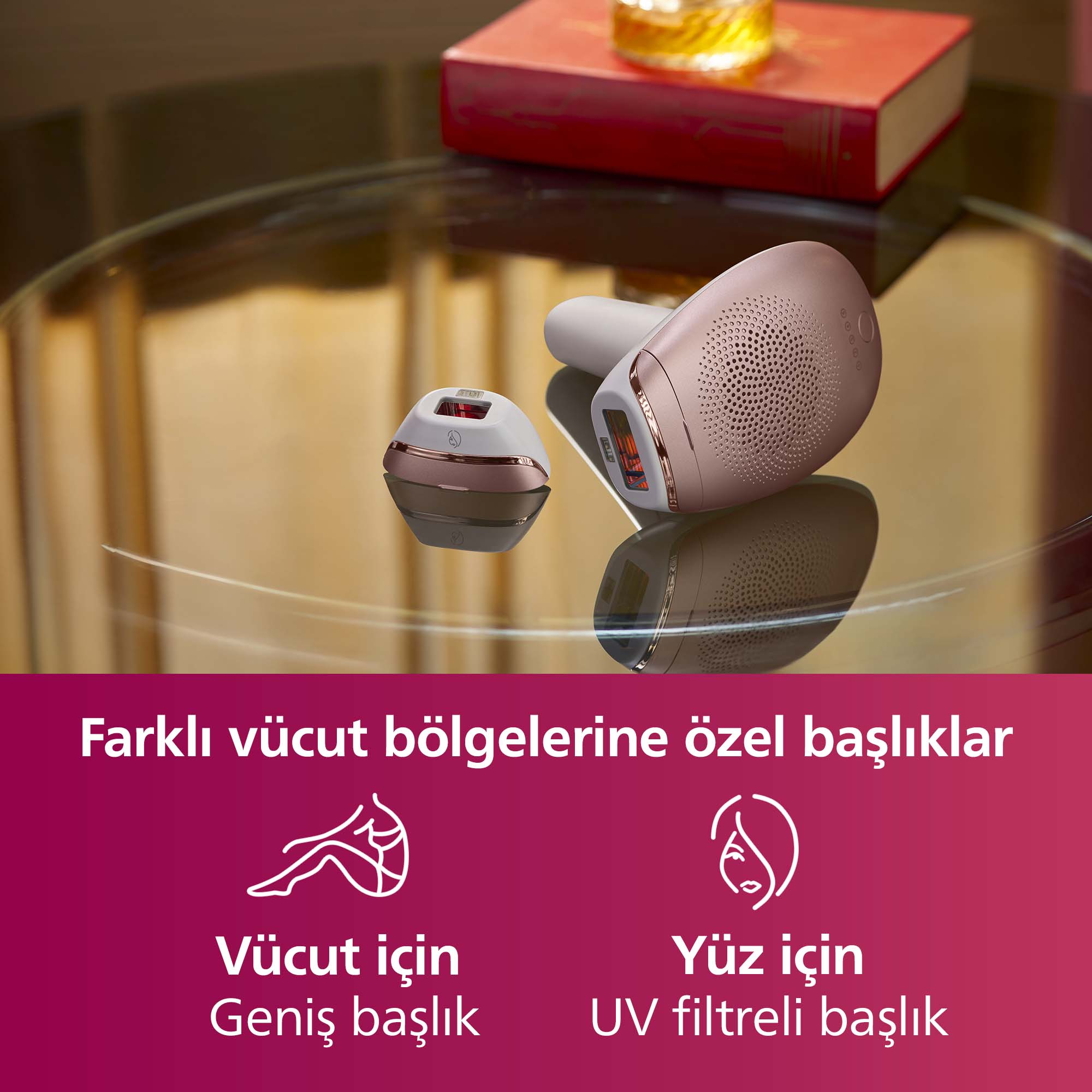 Cam yüzeyde iki epilasyon cihazı. Arkada kitap ve bardak.
