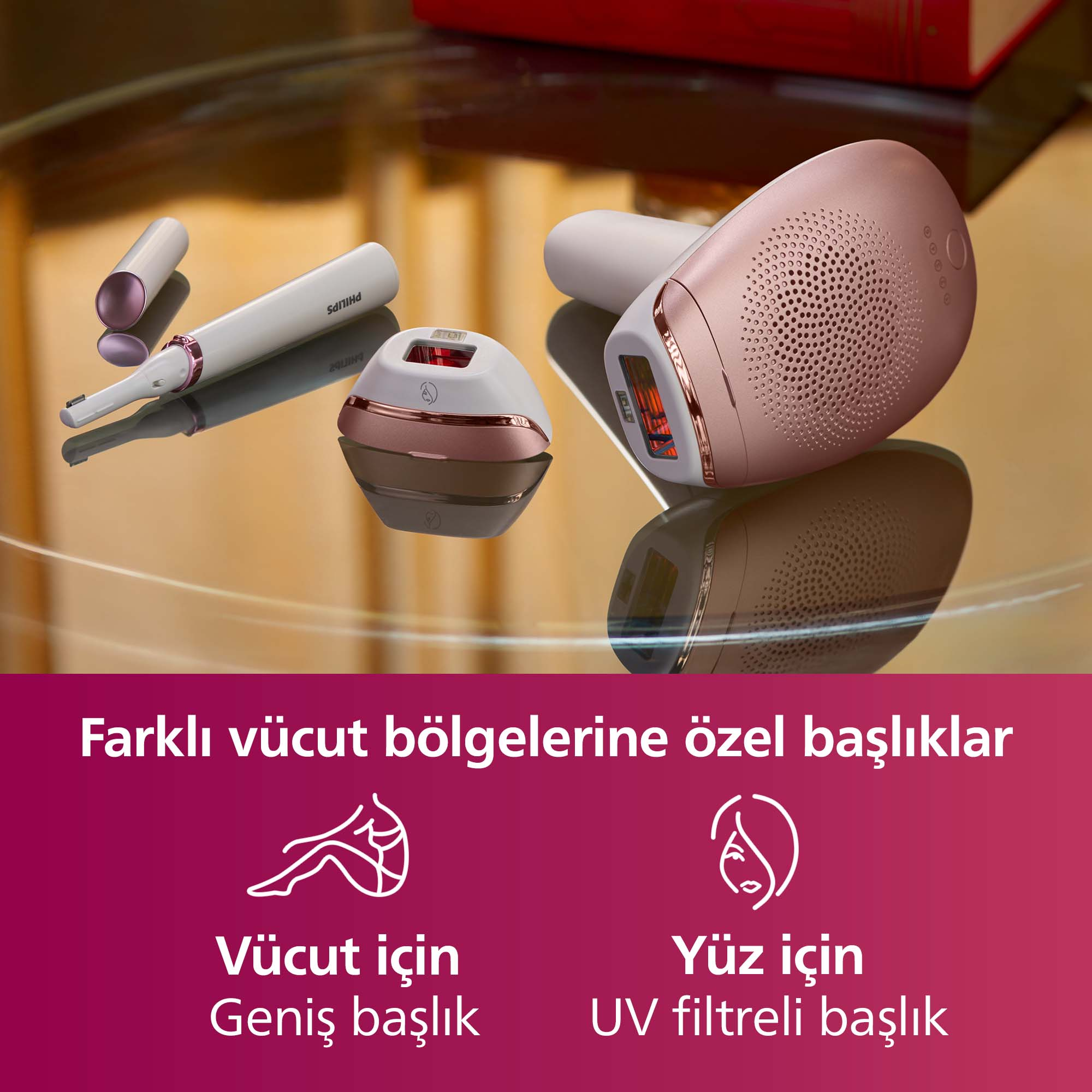 Beyaz, roz altın ve kahverengi Philips epilatörler yansıtıcı yüzeyde.