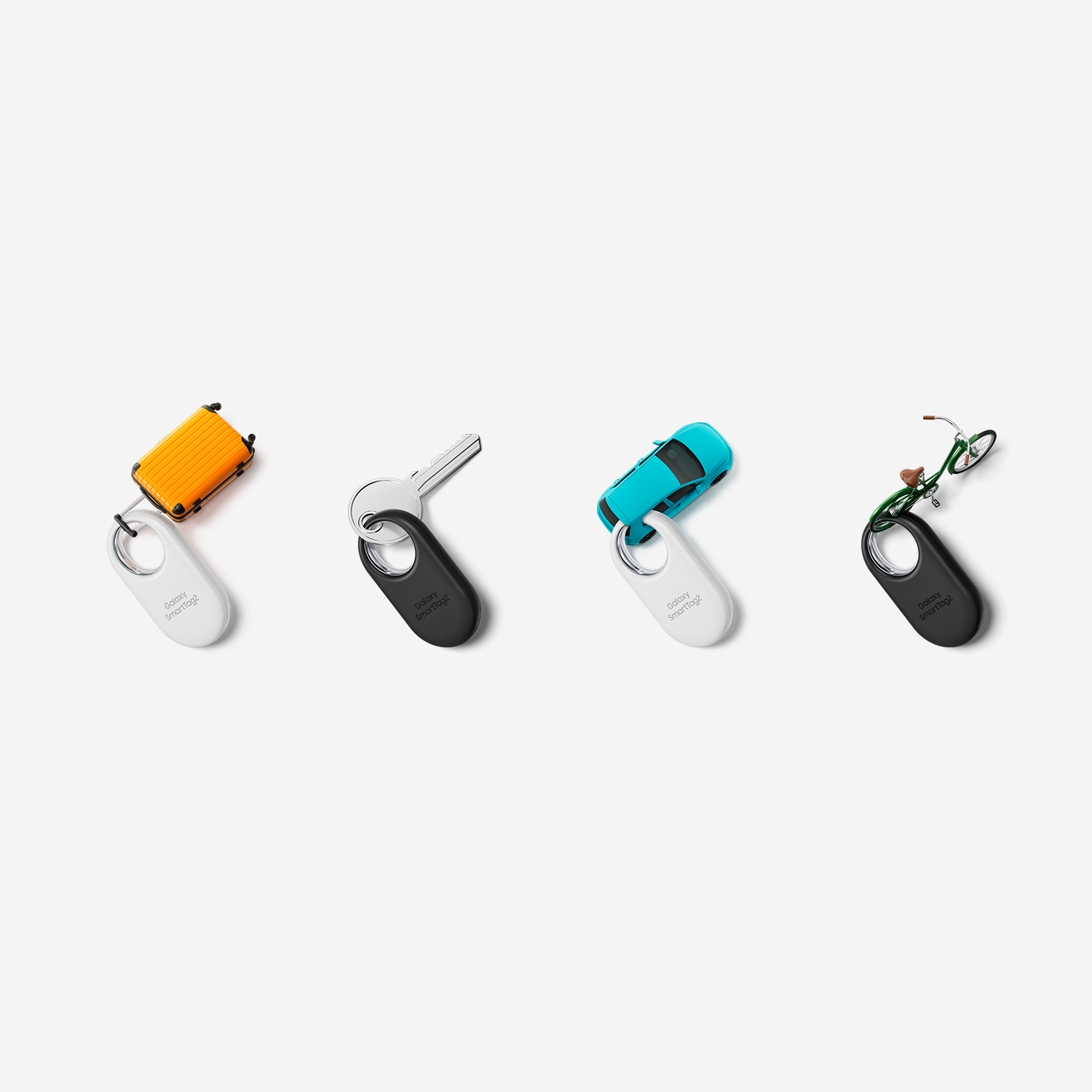 Cuatro llaveros: maleta naranja, llave, coche azul, bicicleta verde sobre blanco.