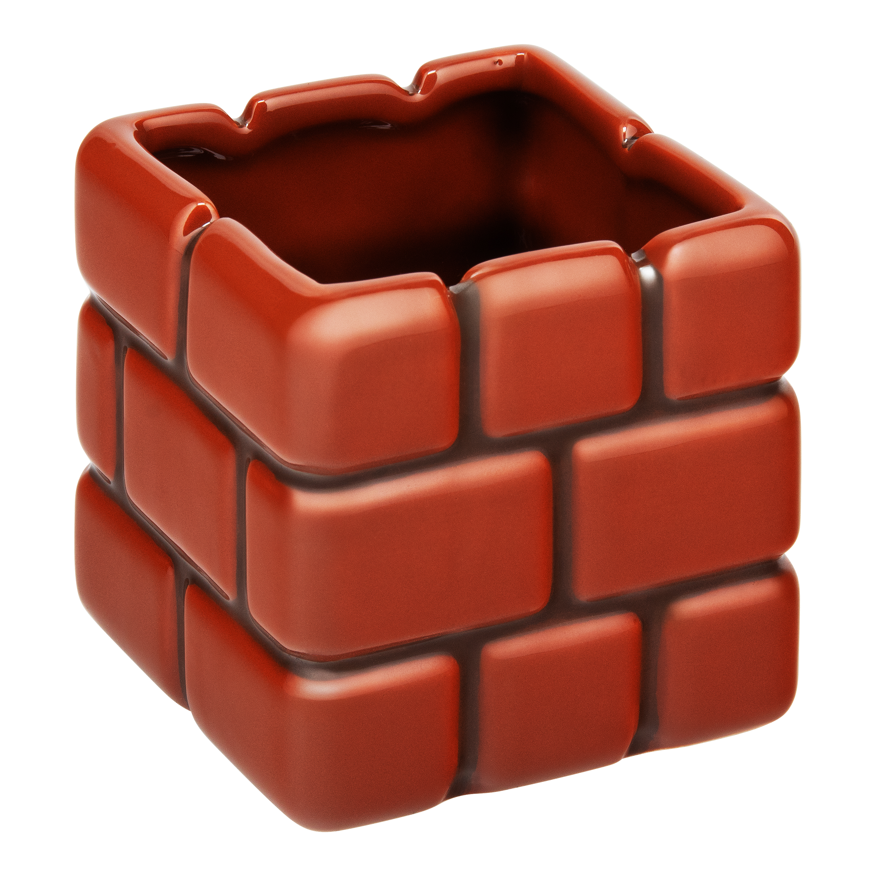 Ein roter Keramik-Aschenbecher mit Ziegelsteinmuster.