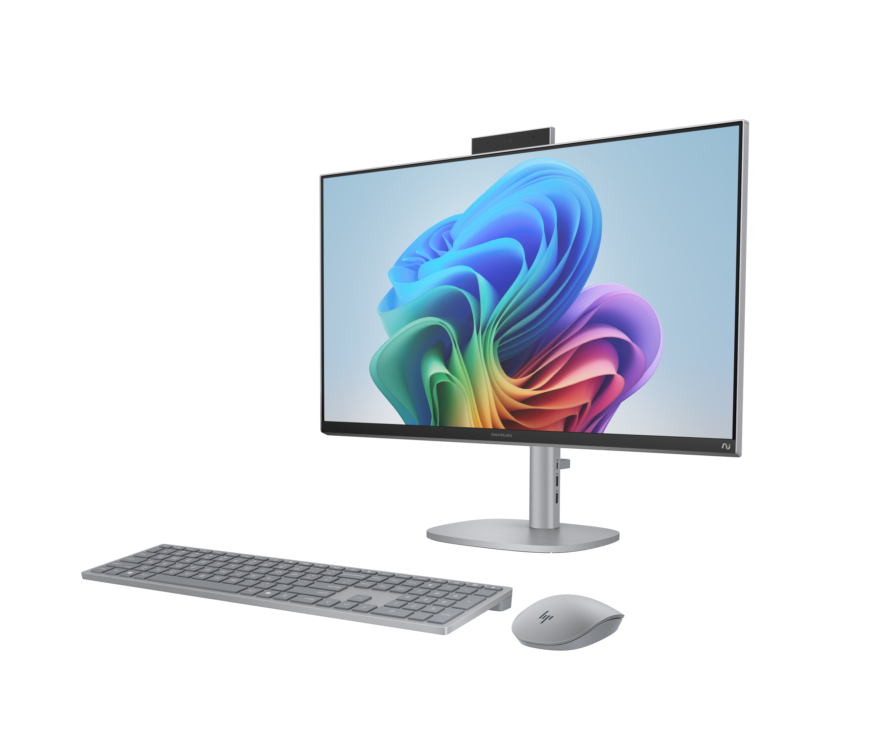 Een zilveren all-in-one computer met toetsenbord en muis op zwarte achtergrond.