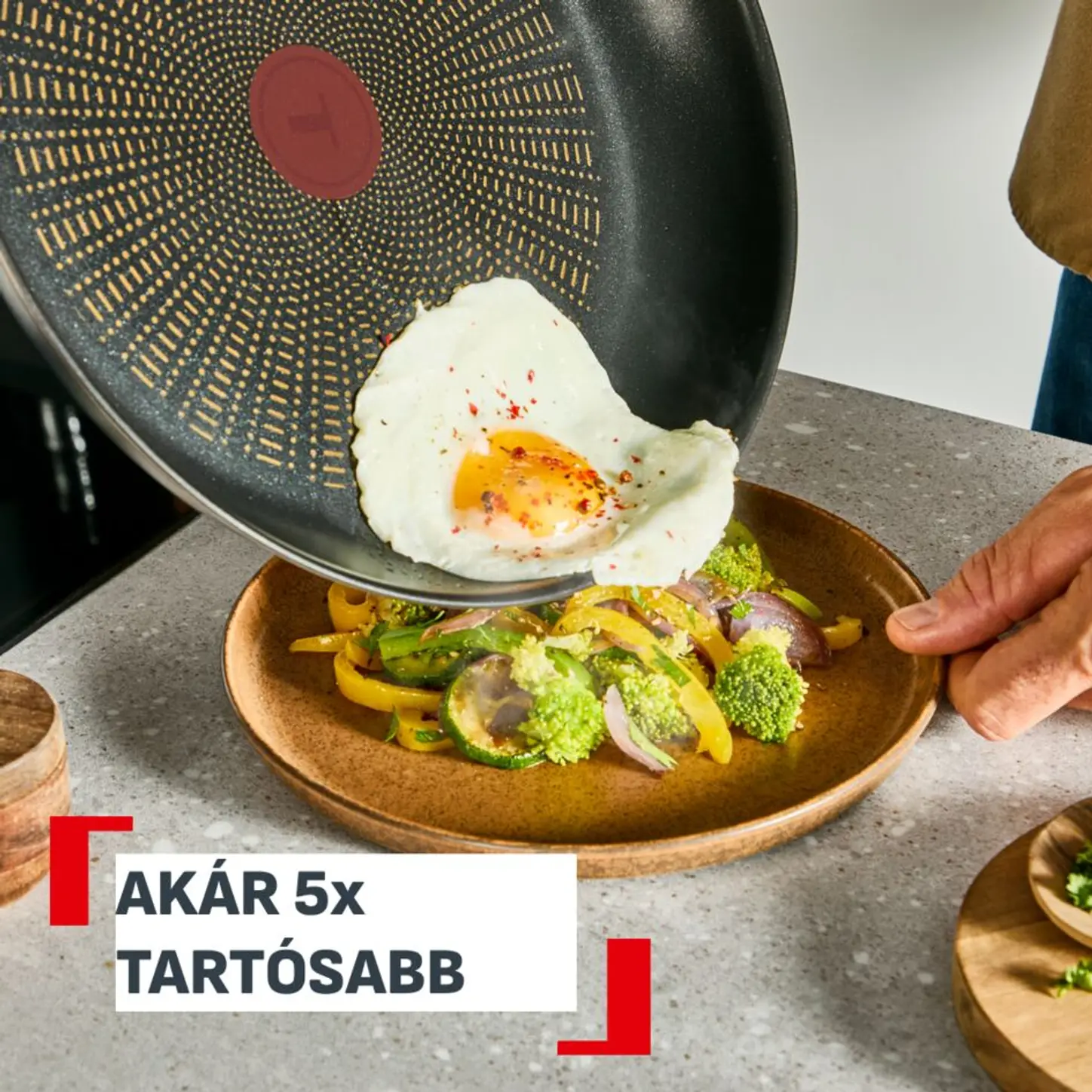 Egy tükörtojást egy serpenyőből zöldségekre öntenek egy tányéron.