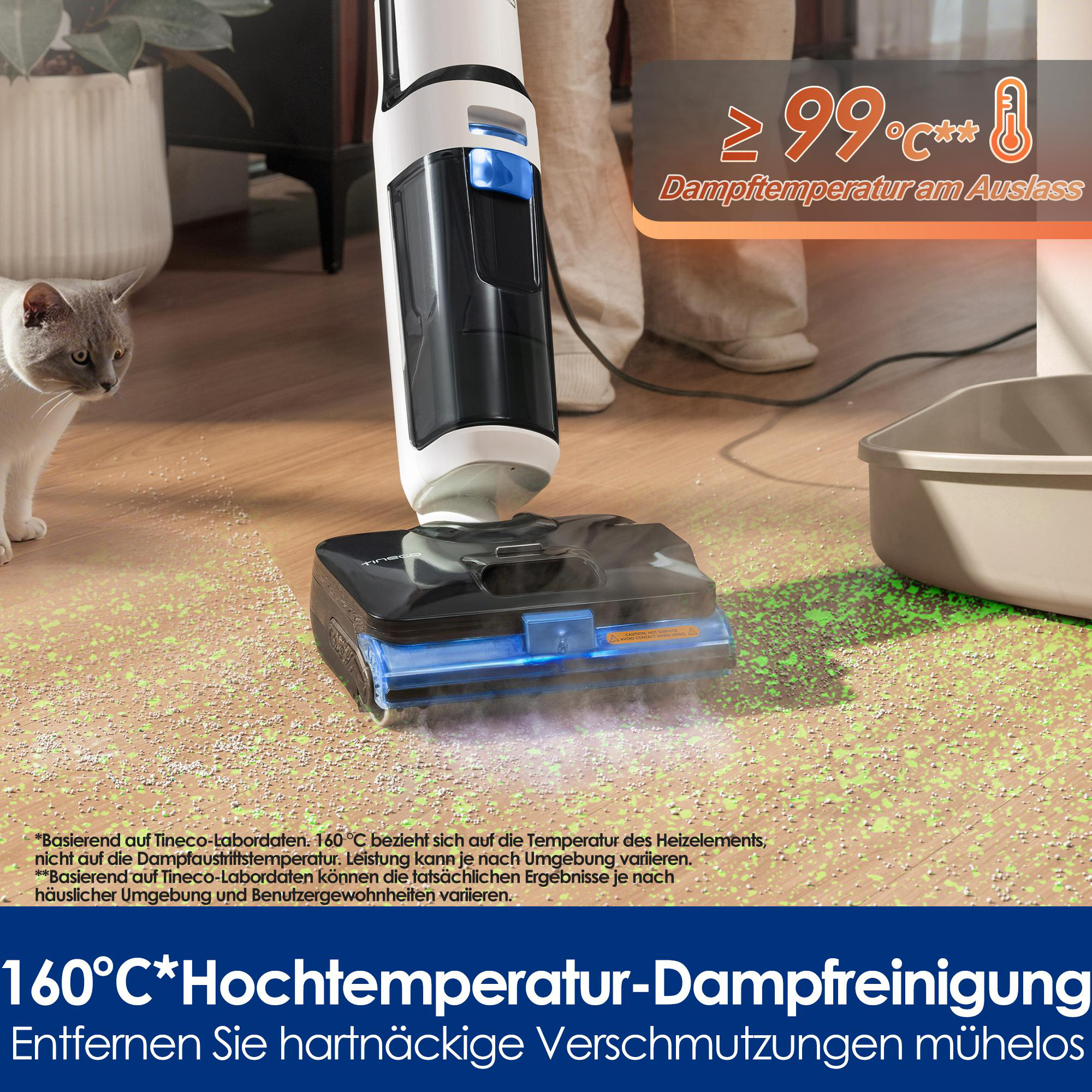Ein Dampfreiniger mit Heizelement über 99°C reinigt den Boden. Eine Katze beobachtet.