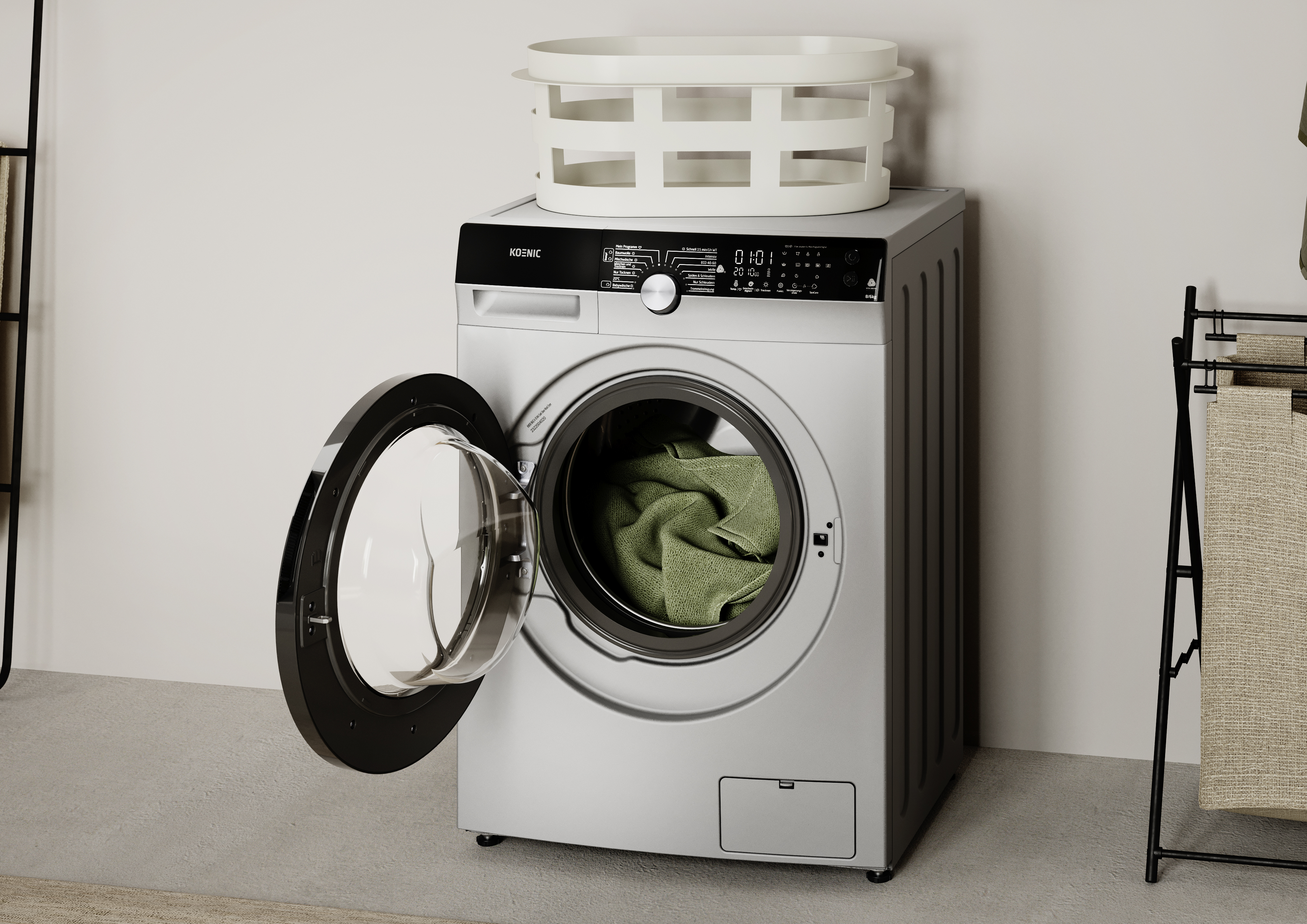 Eine silberne Waschmaschine mit geöffneter Tür und grünen Handtüchern.