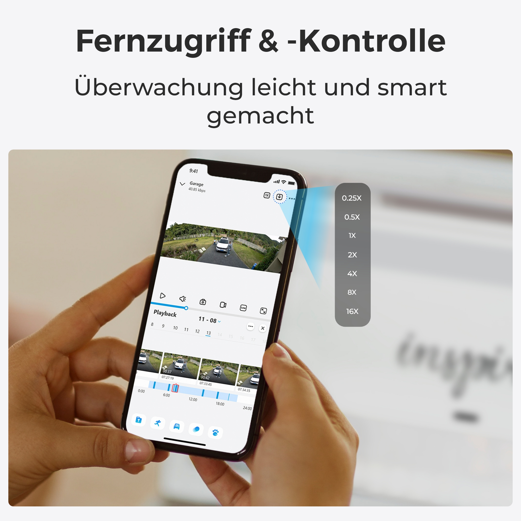 Eine Person hält ein Smartphone, das eine Überwachungskamera-App zeigt.