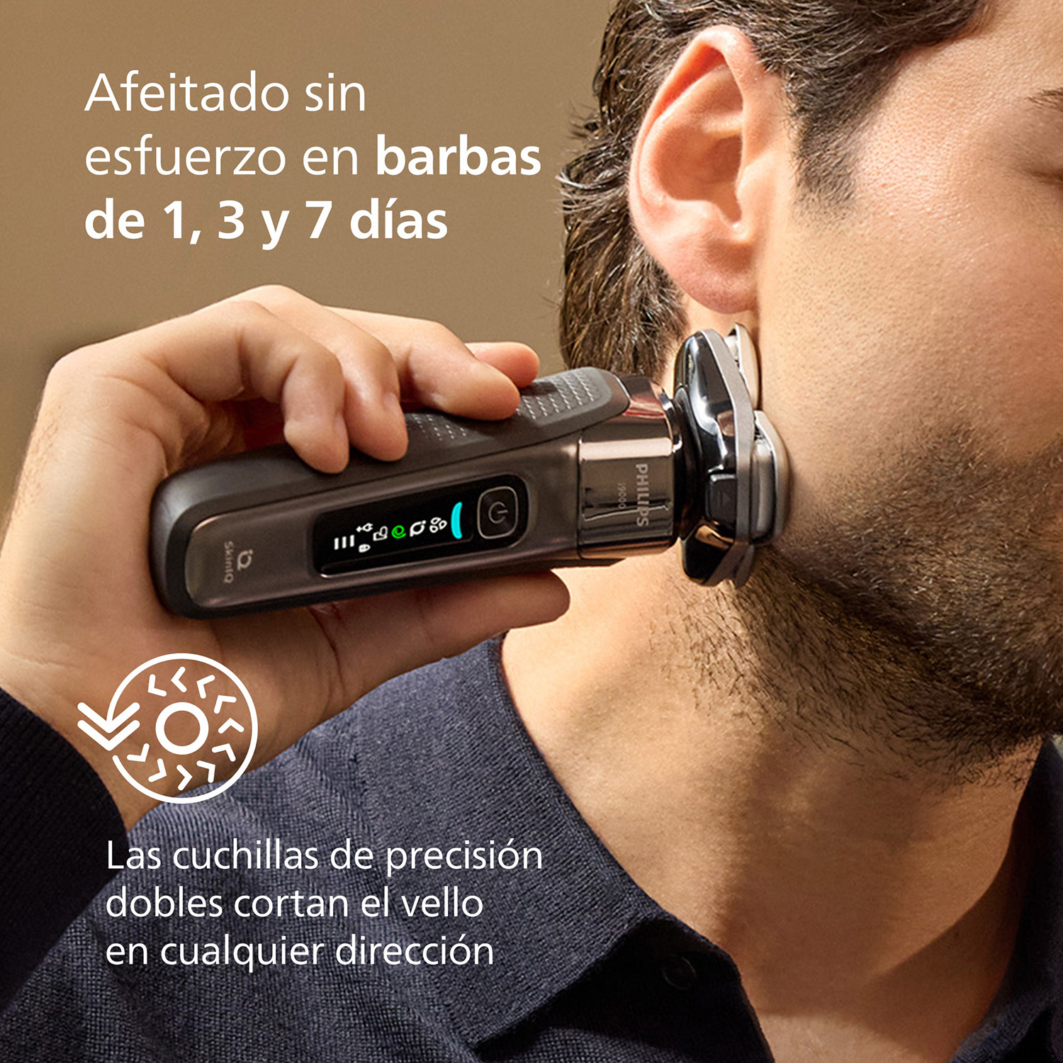 Hombre usando afeitadora Philips i9000. Texto: Afeitado sin esfuerzo en barbas de 1, 3 y 7 días, cuchillas dobles cortan el vello en cualquier dirección.