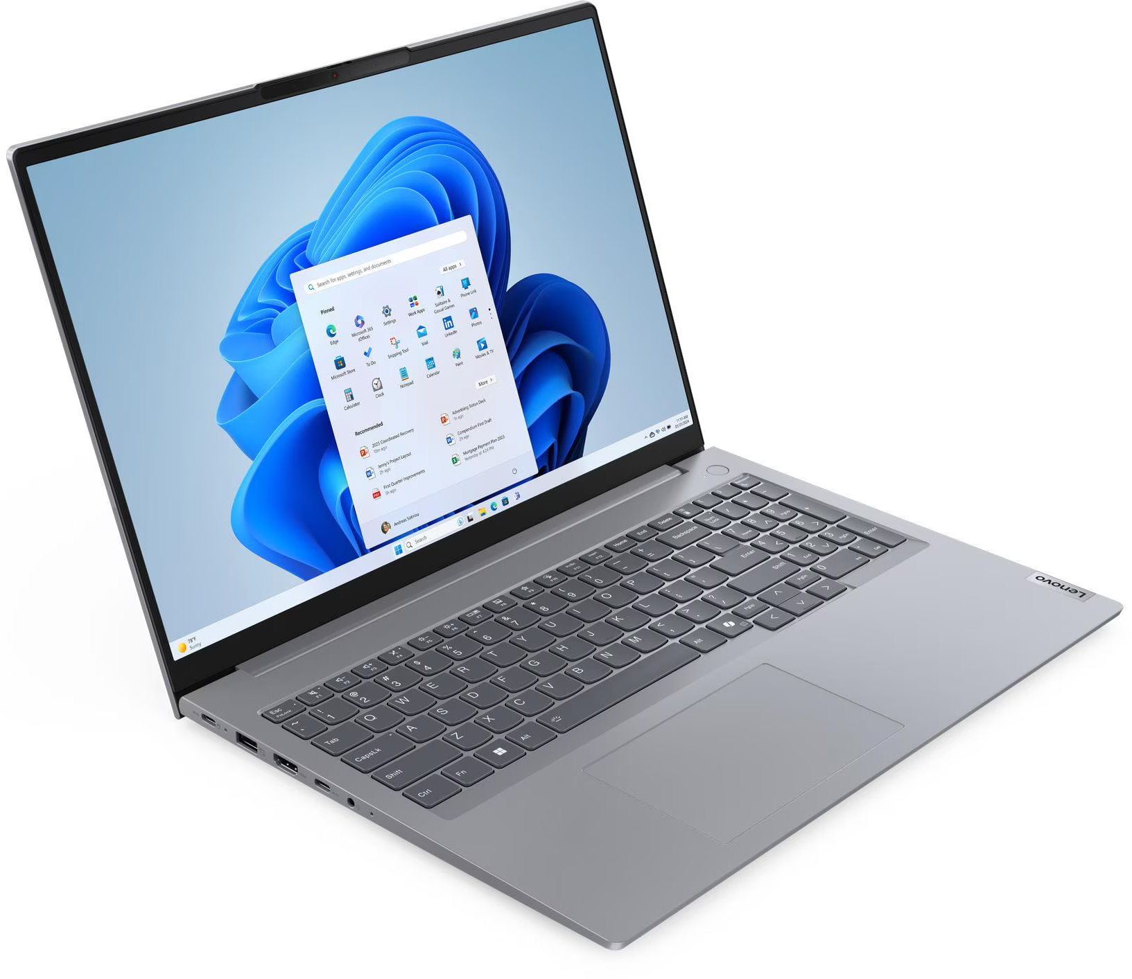 Egy ezüst laptop bekapcsolt képernyővel, Windows 11 rendszert mutatva.