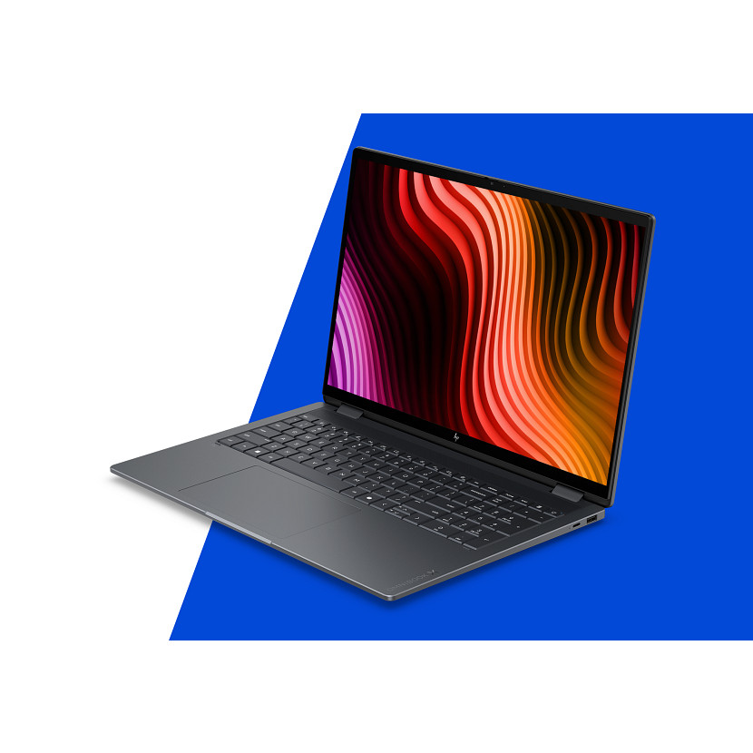 Ein geschlossenes dunkles Laptop mit einem bunten Wellenmuster auf dem Bildschirm.