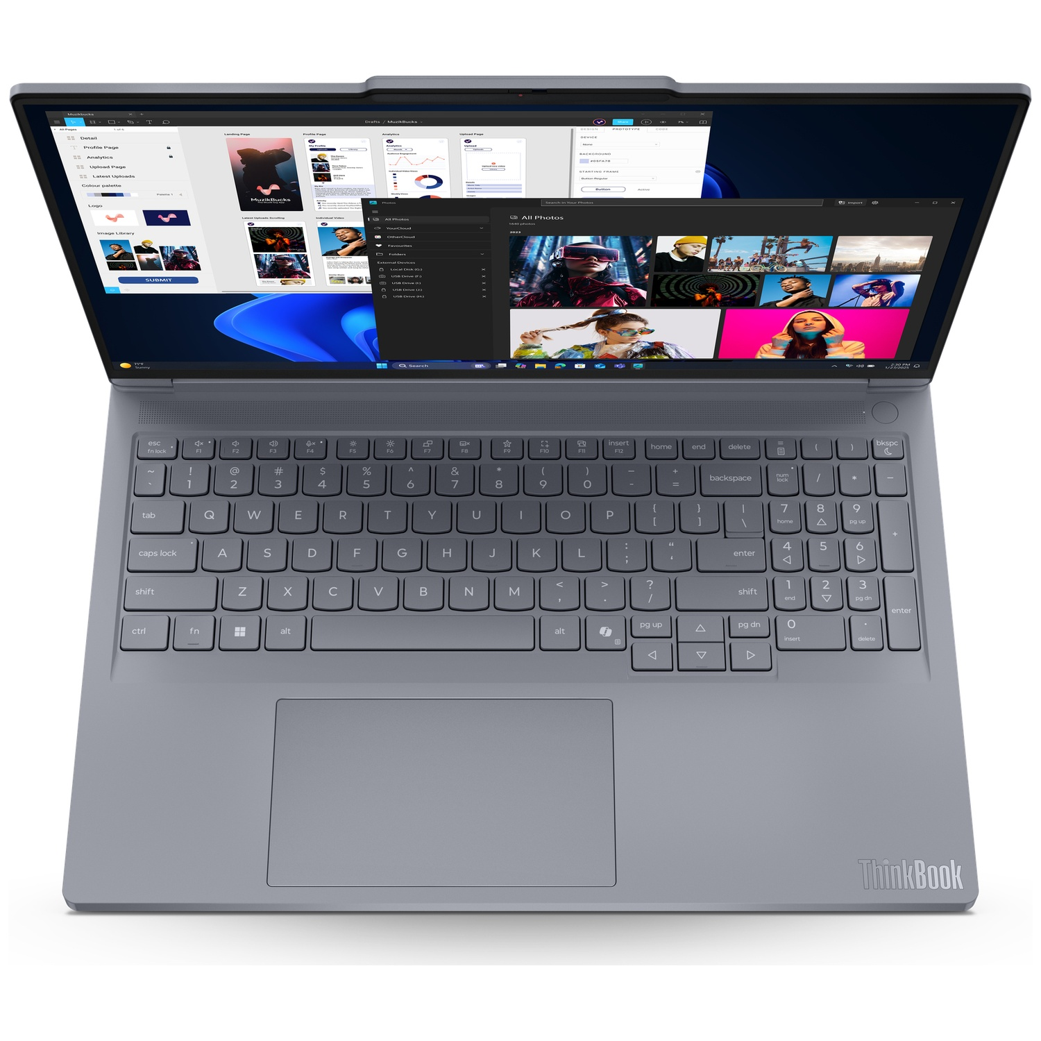 Gray laptop with open screen showing design and photo applications.