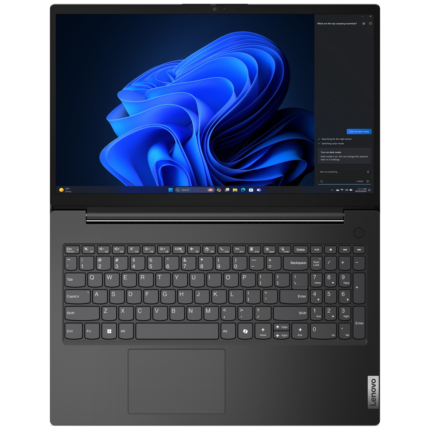 Een gesloten grijze laptop met een blauwe abstracte achtergrond op het scherm.