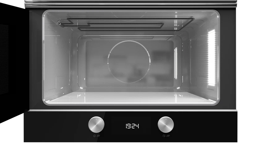 Interior vacío y limpio de un microondas moderno con luces encendidas.
