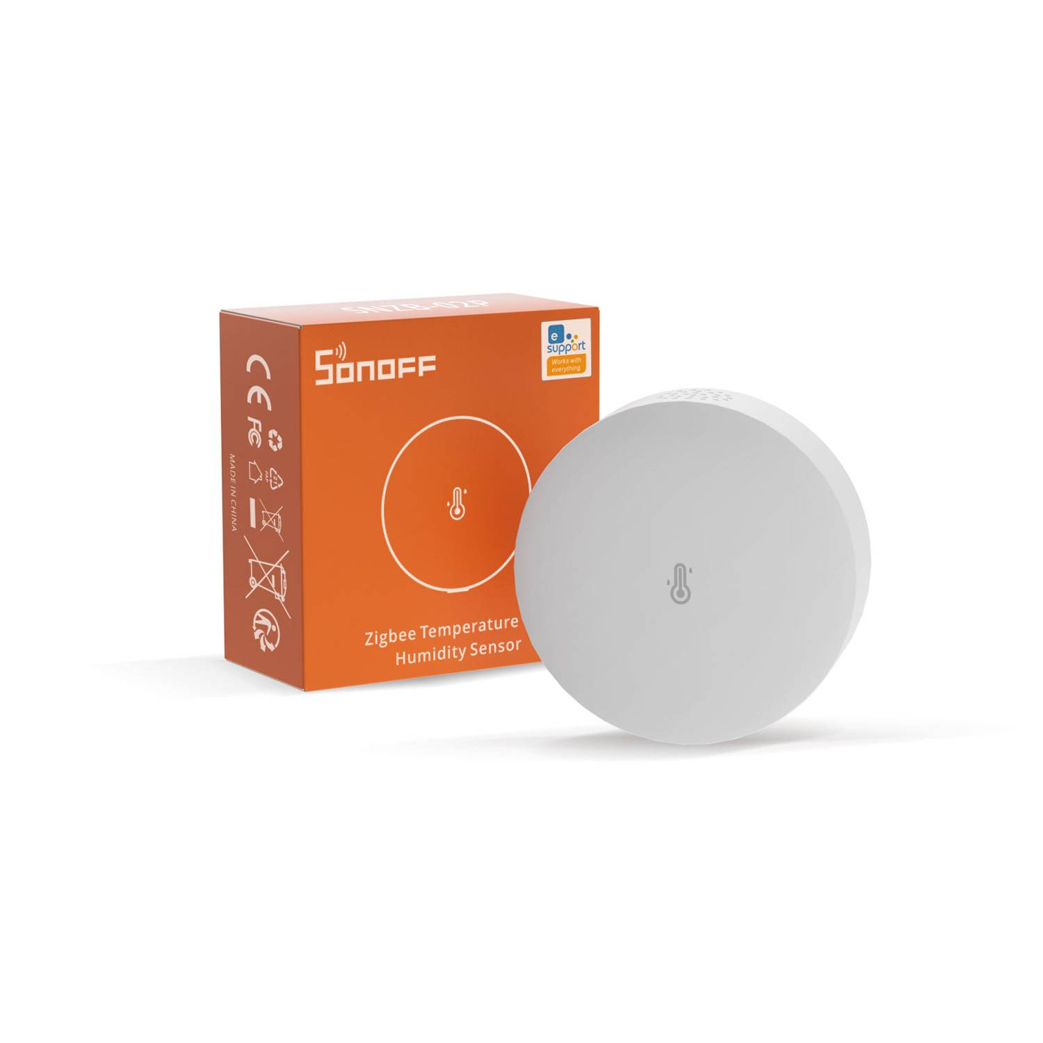Sensor blanco Zigbee de temperatura y humedad junto a paquete naranja.