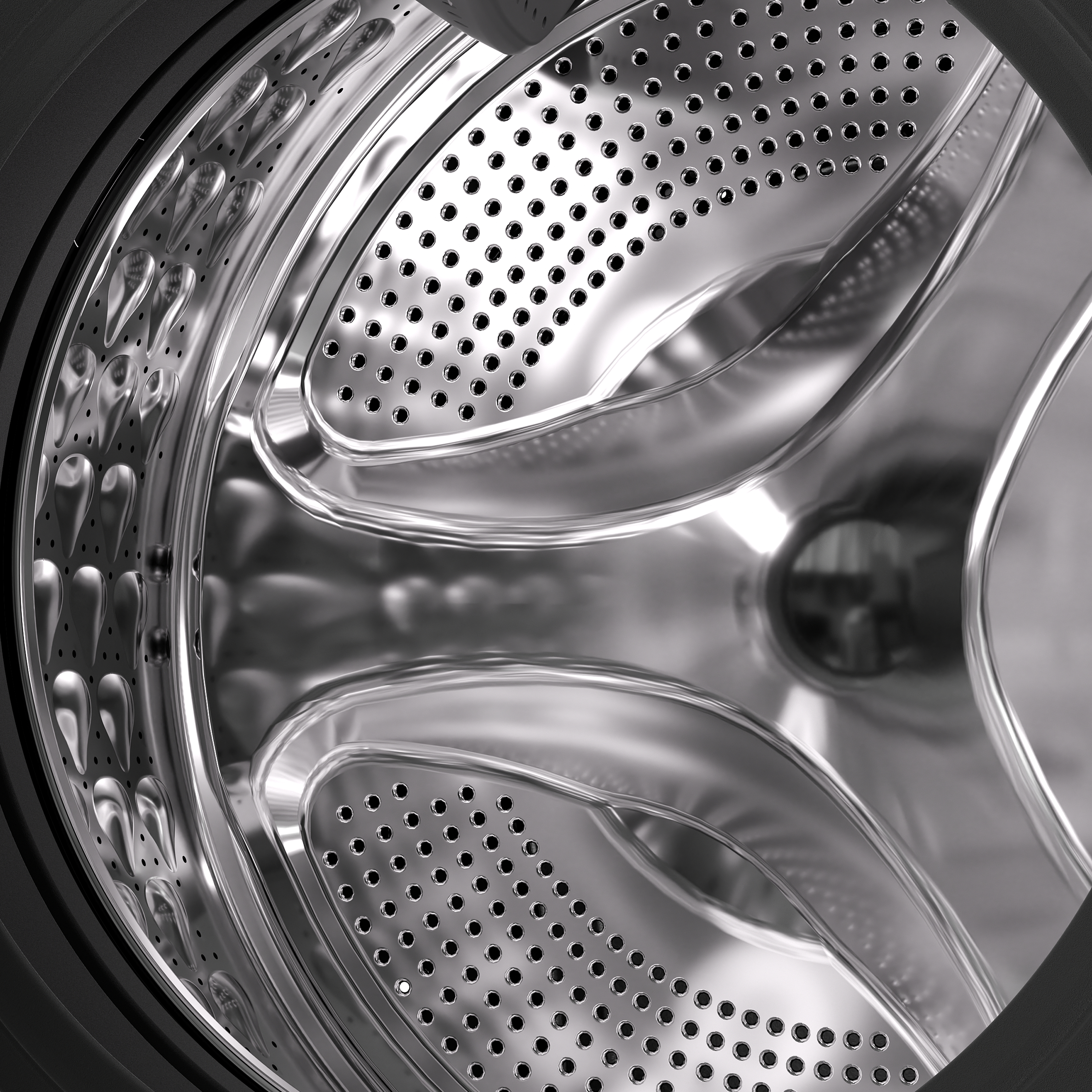 Das Innere einer Waschmaschinentrommel aus Metall mit Perforationen und Erhebungen.