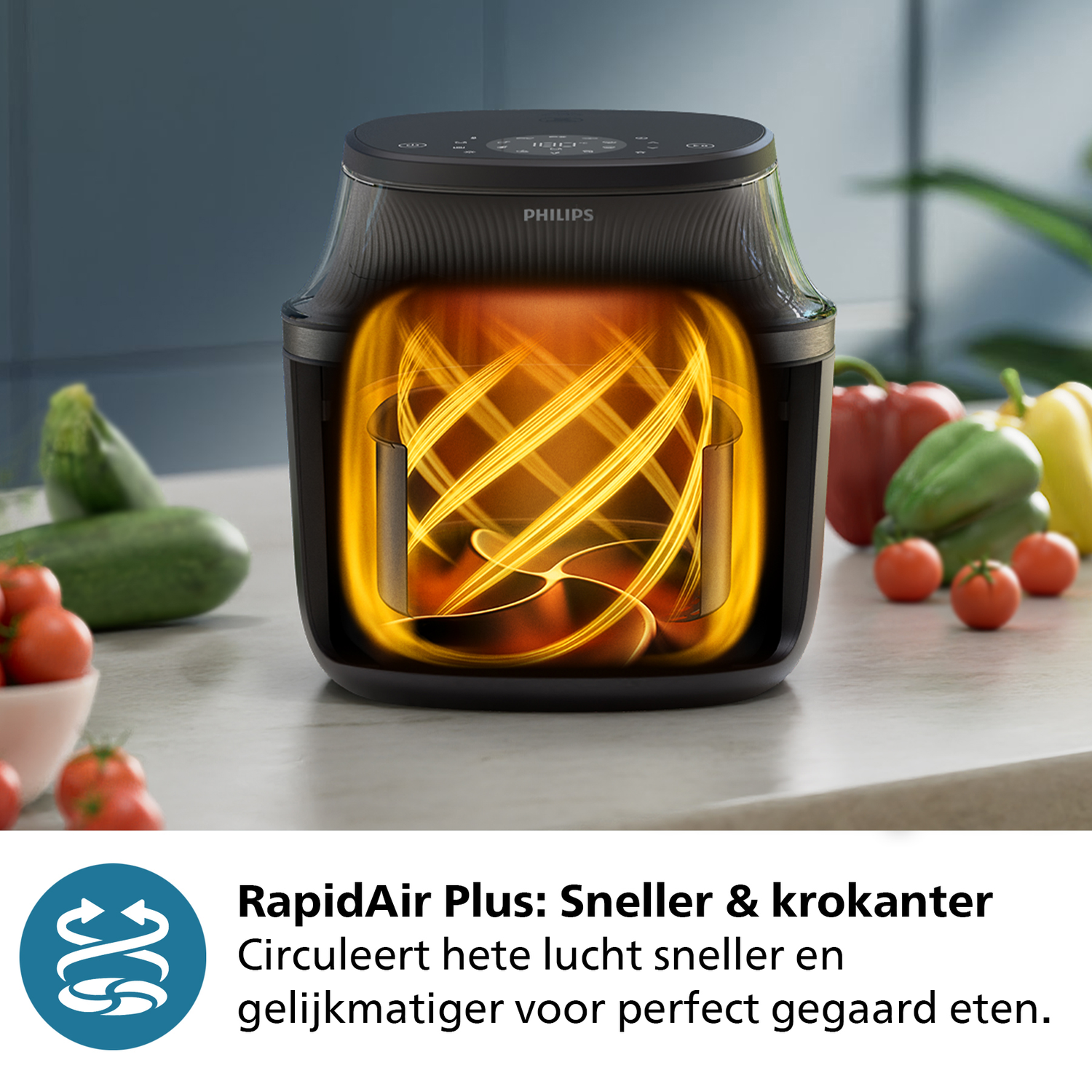 Zwarte Philips airfryer met wervelende hitte en groenten.